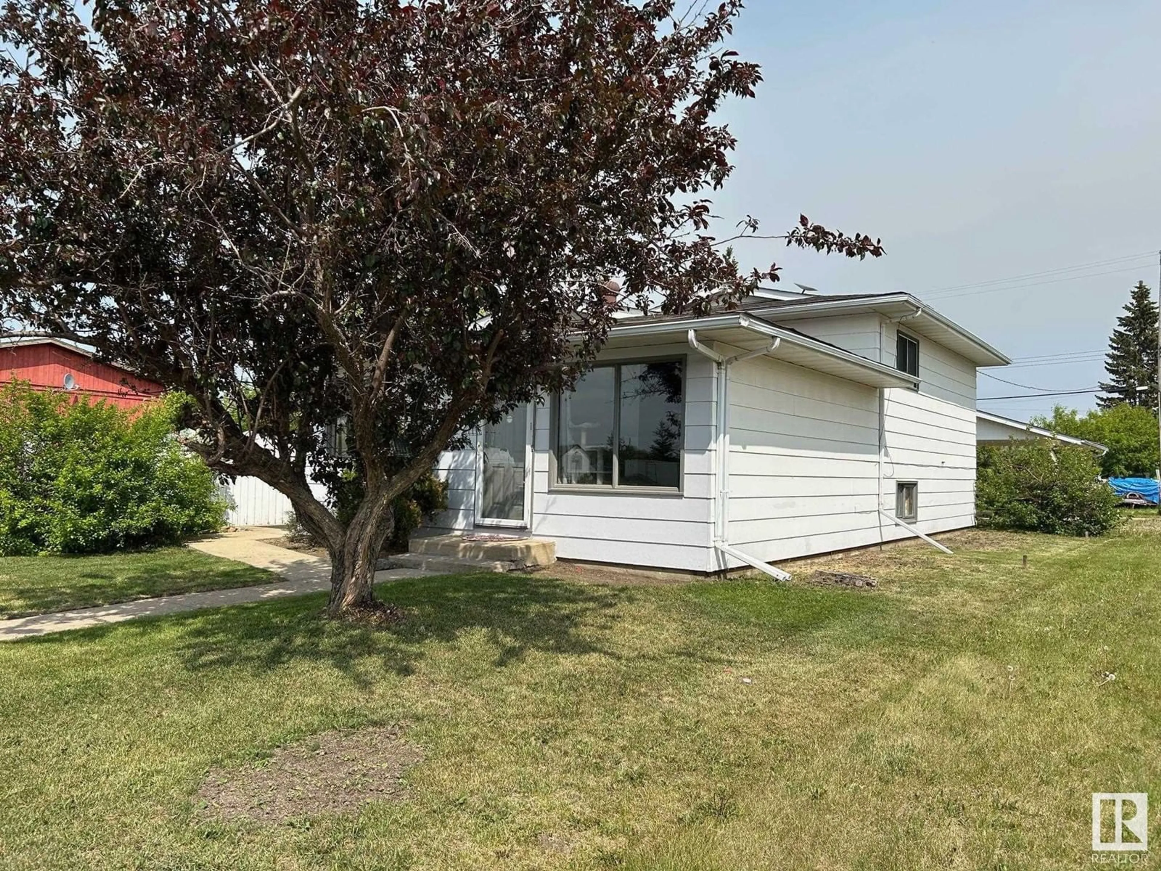Home with vinyl exterior material, street for 809 2 ST, Thorhild Alberta T0A3J0