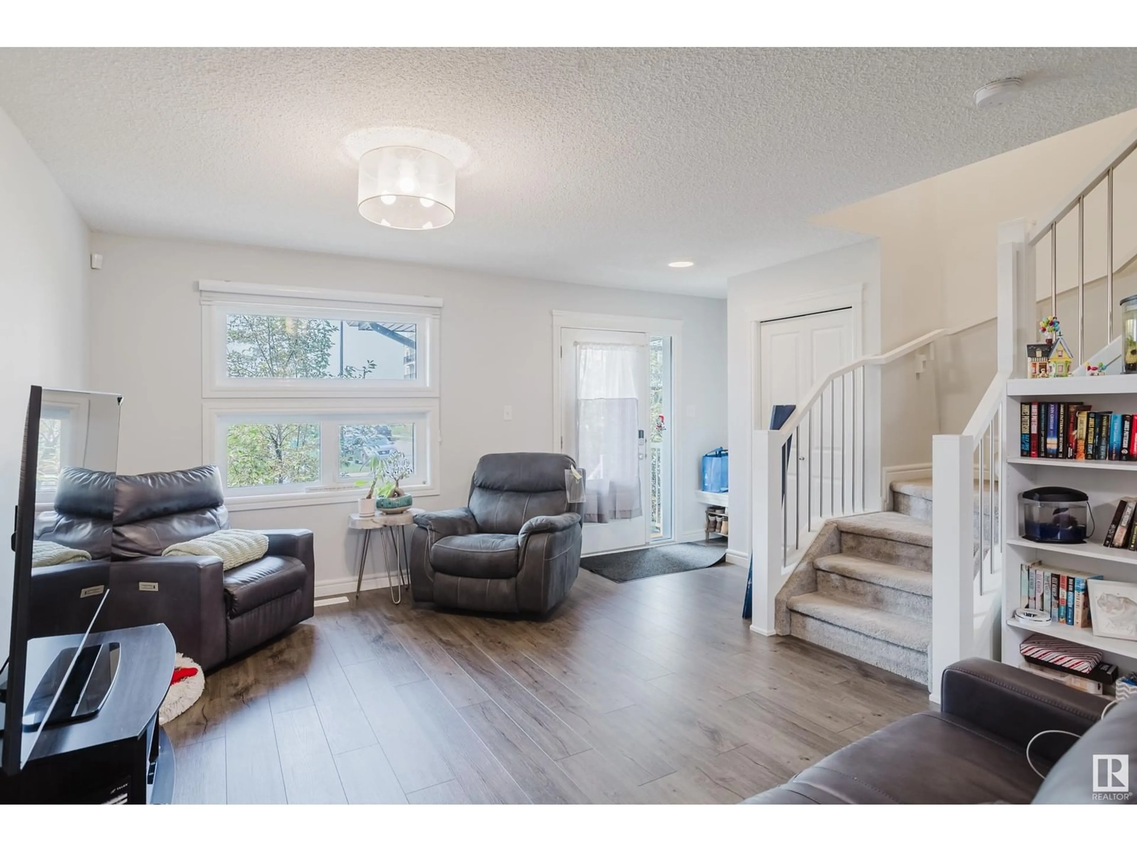 Living room with furniture, wood/laminate floor for 5654 JUCHLI AV, Edmonton Alberta T5E6X5