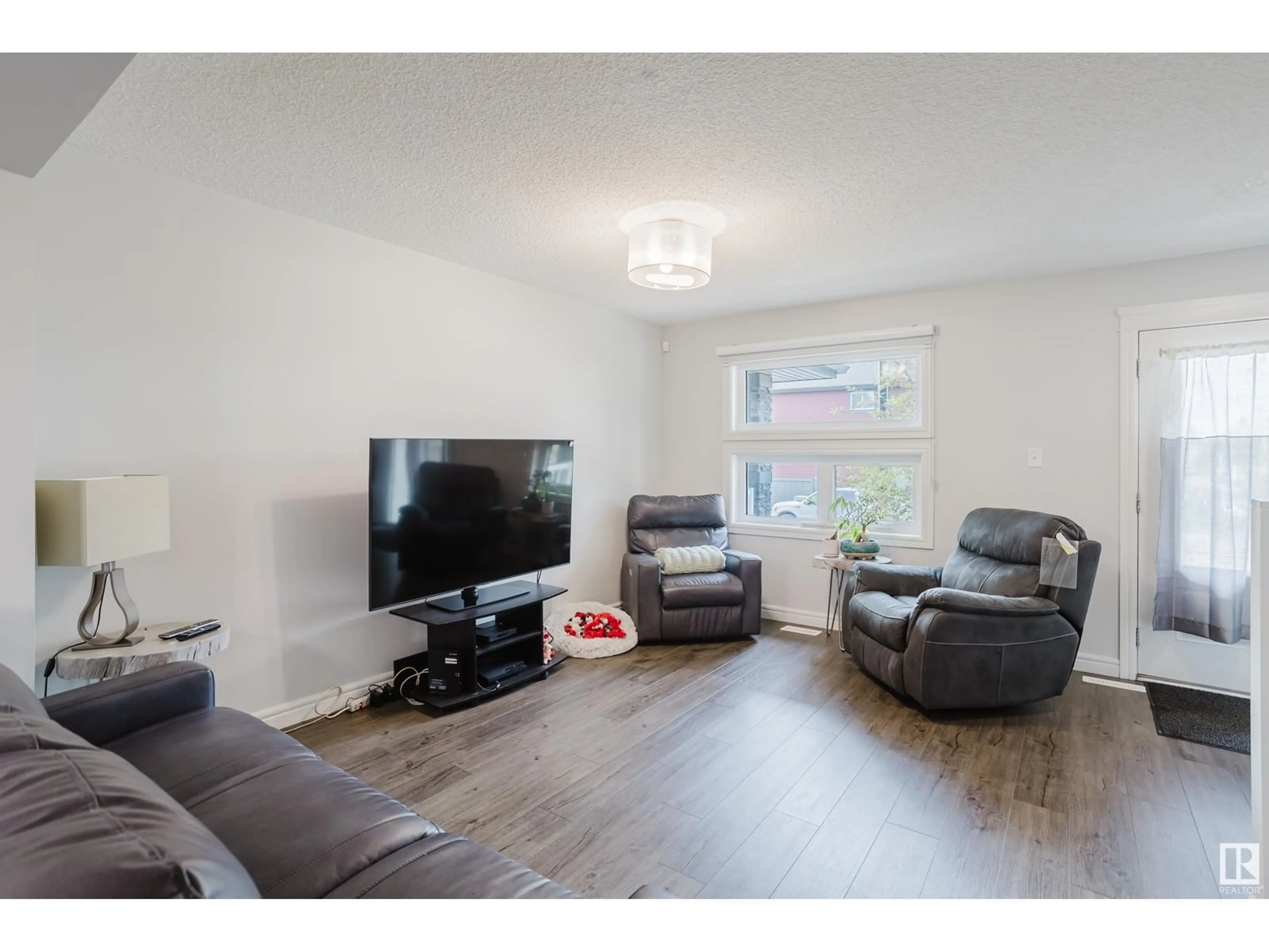 Living room with furniture, wood/laminate floor for 5654 JUCHLI AV, Edmonton Alberta T5E6X5