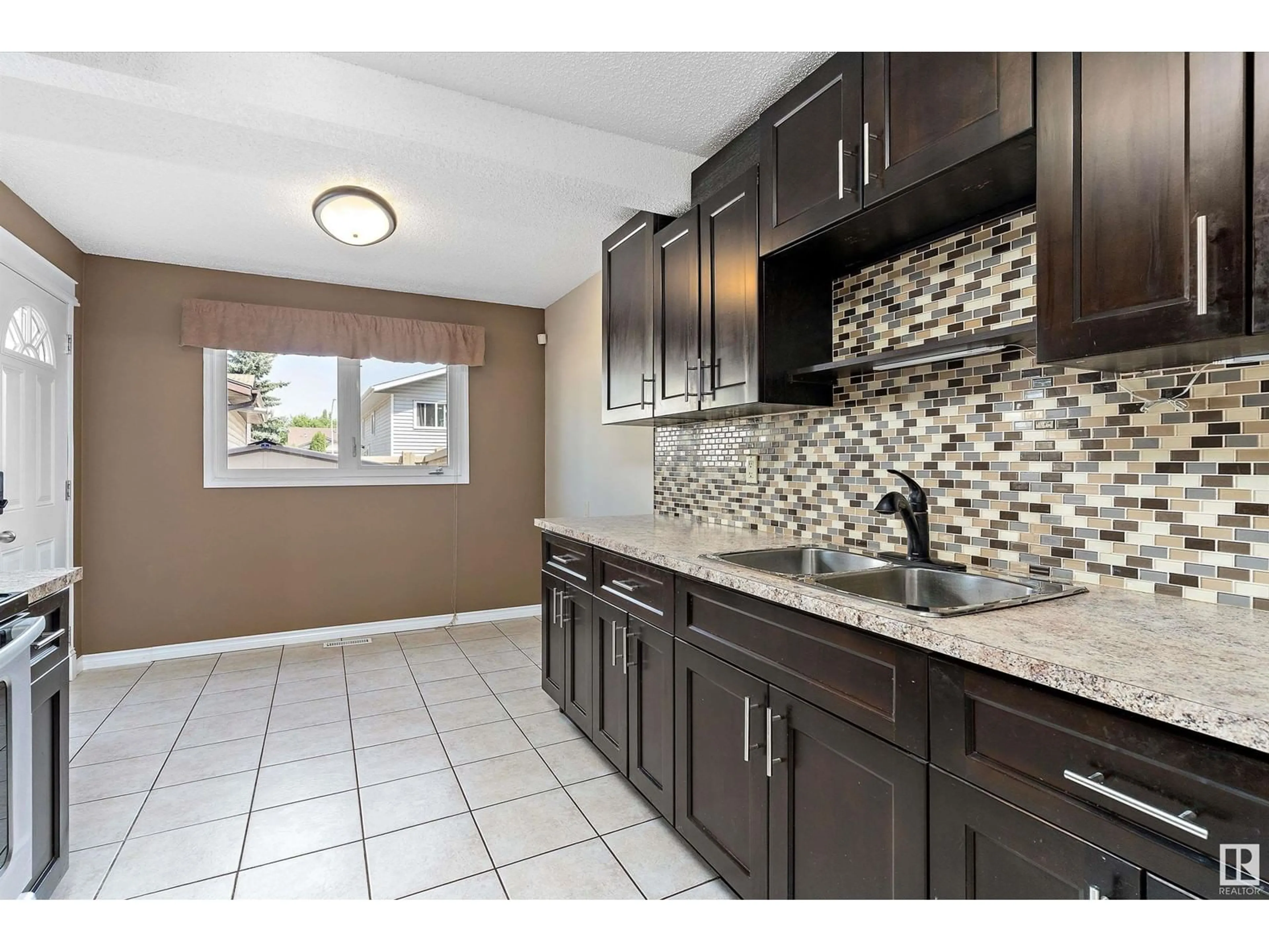 Open concept kitchen, ceramic/tile floor for NW - 14795 25 ST, Edmonton Alberta T5Y2E8