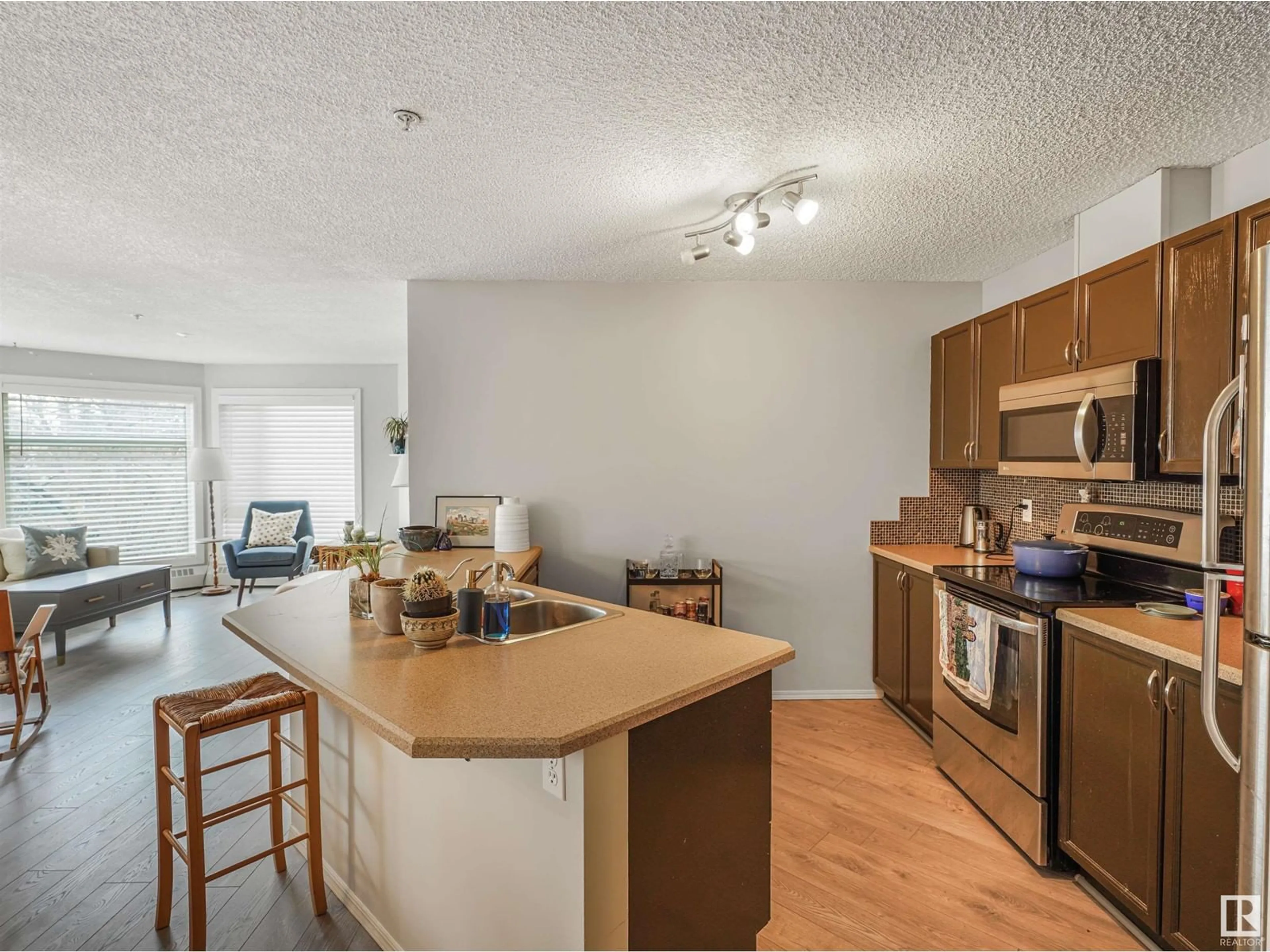 Open concept kitchen, wood/laminate floor for #306 - 9905 112 ST, Edmonton Alberta T5K1L6