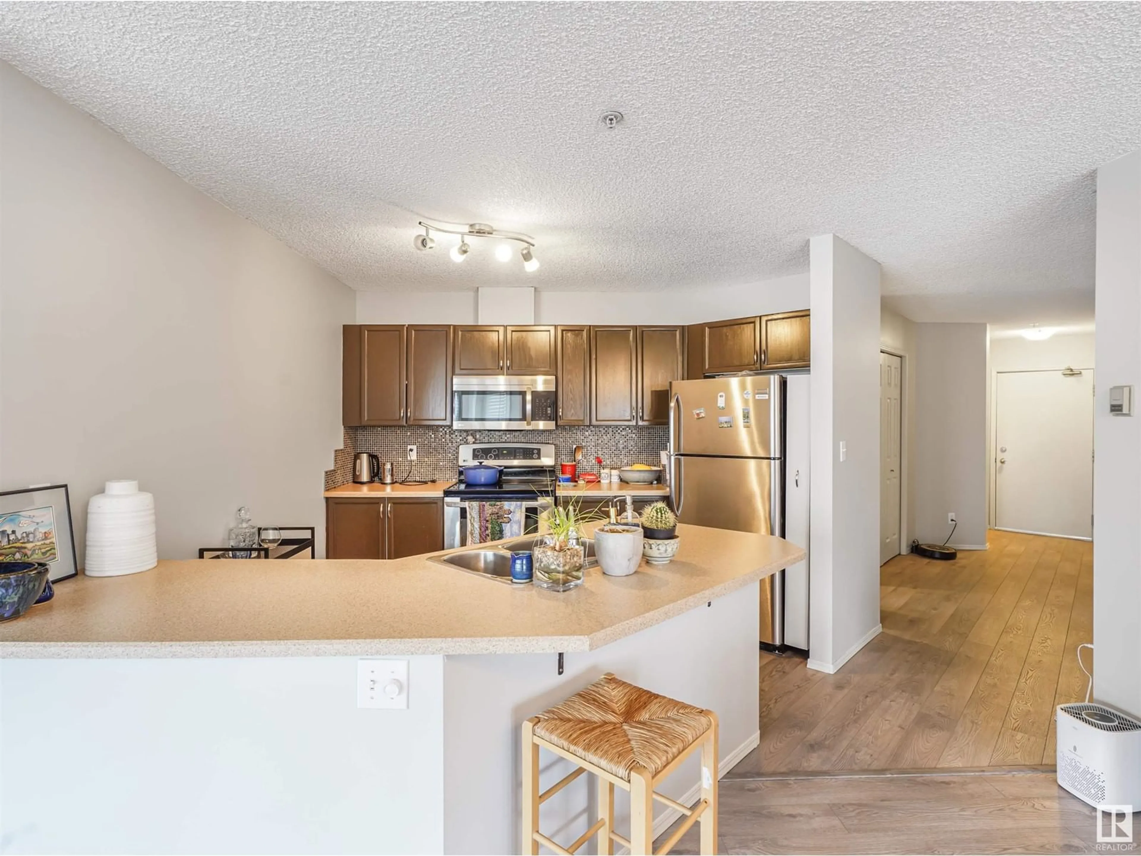 Open concept kitchen, wood/laminate floor for #306 - 9905 112 ST, Edmonton Alberta T5K1L6