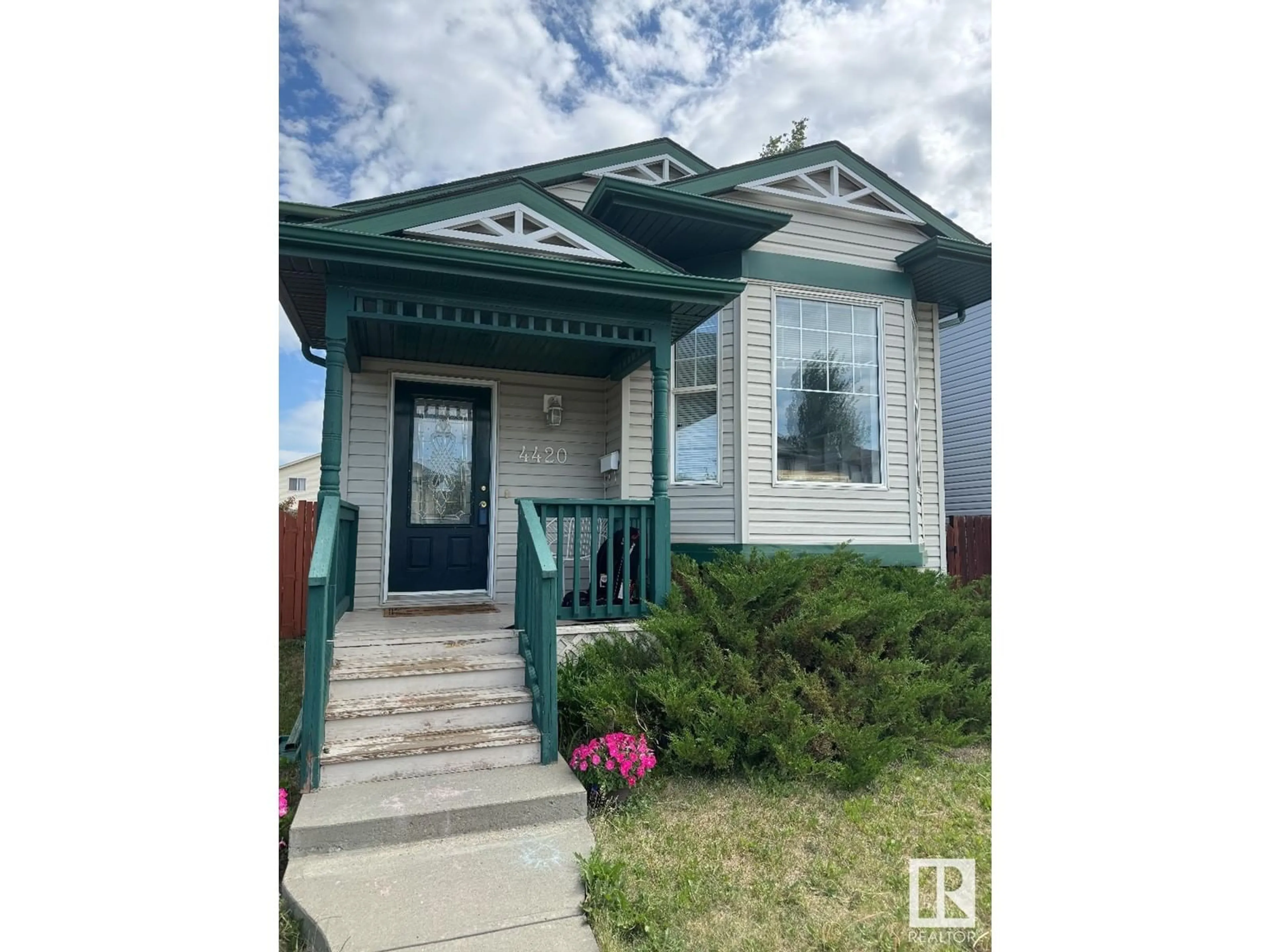 Home with vinyl exterior material, street for NW - 4420 150 AV, Edmonton Alberta T5Y2Z9