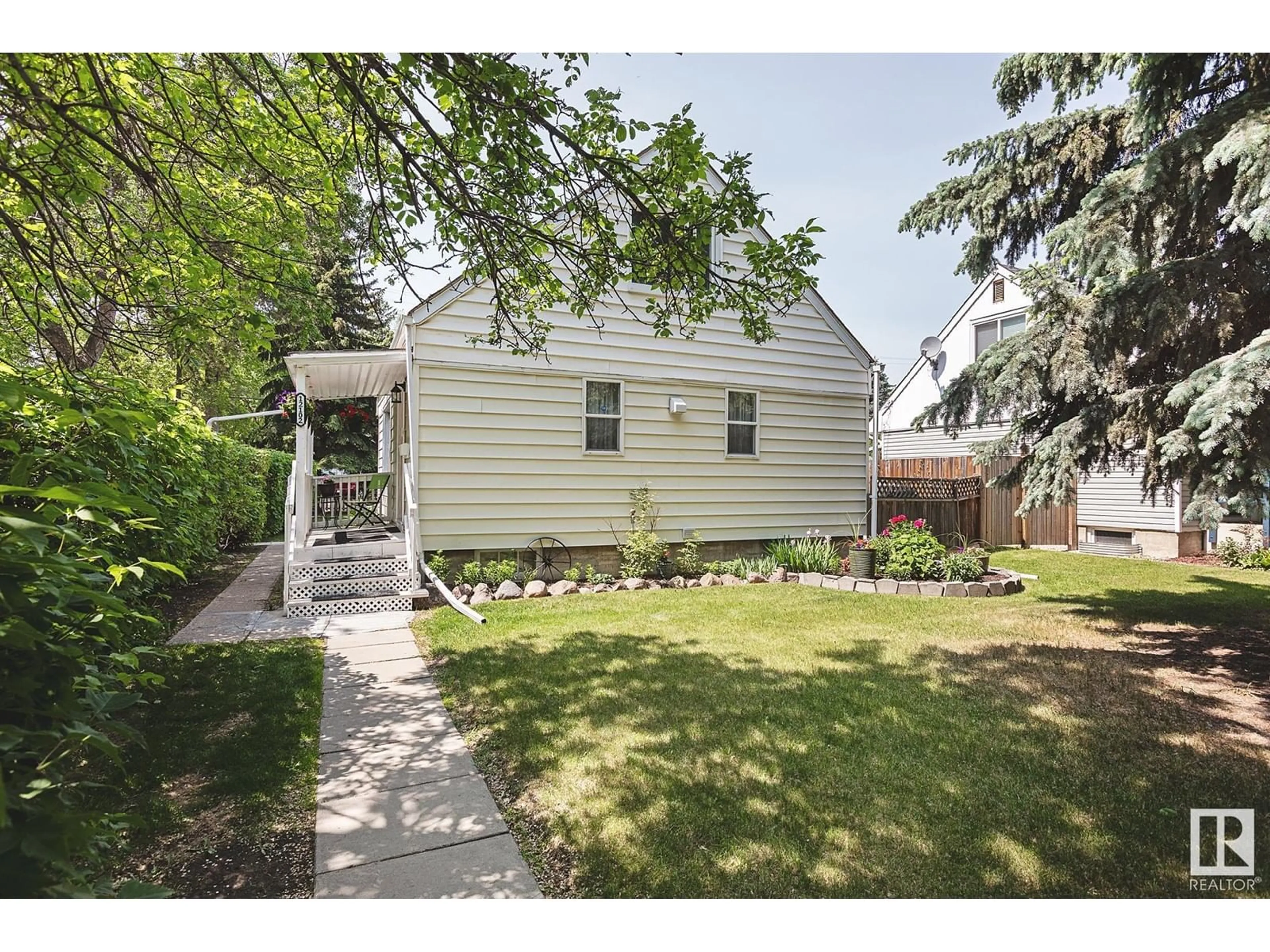 Home with vinyl exterior material, street for 12102 58 ST, Edmonton Alberta T5W3X4