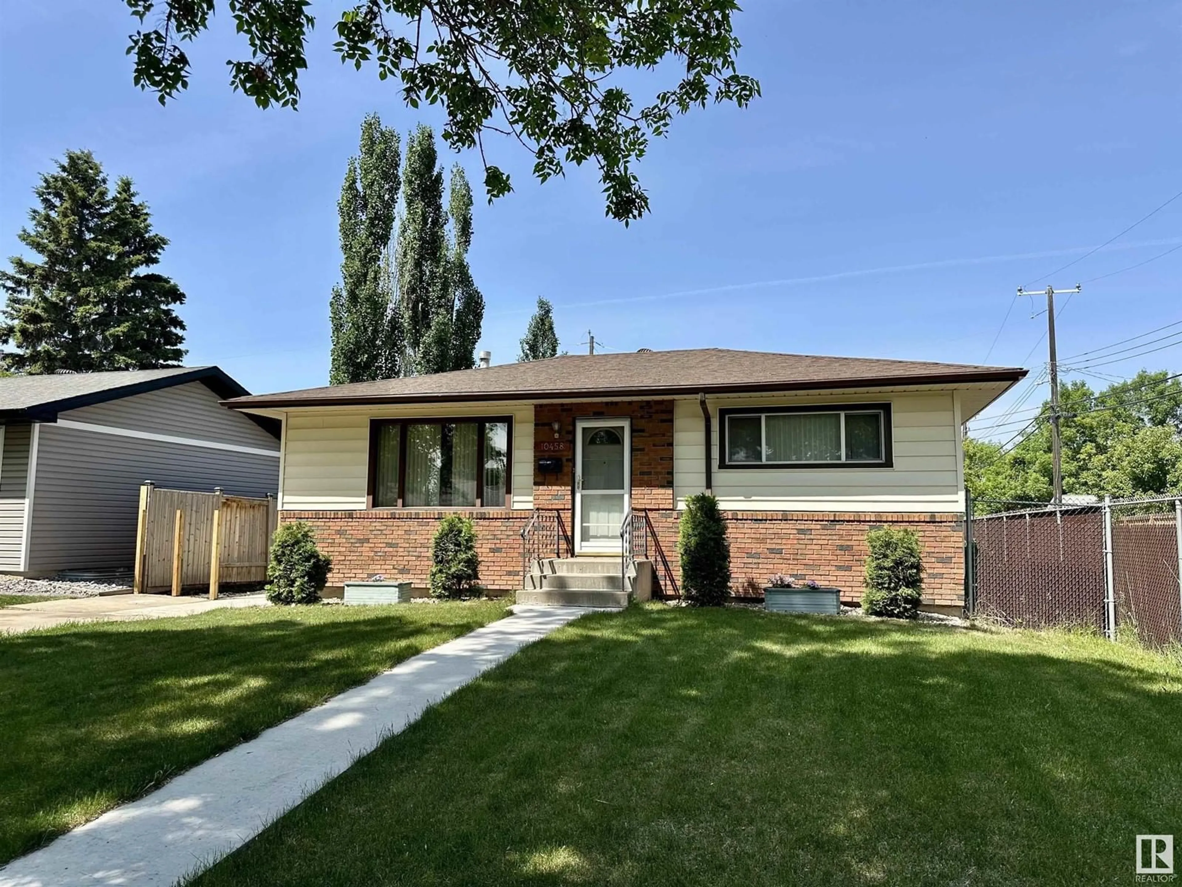 Home with vinyl exterior material, street for NW - 10458 166 ST, Edmonton Alberta T5P4C7