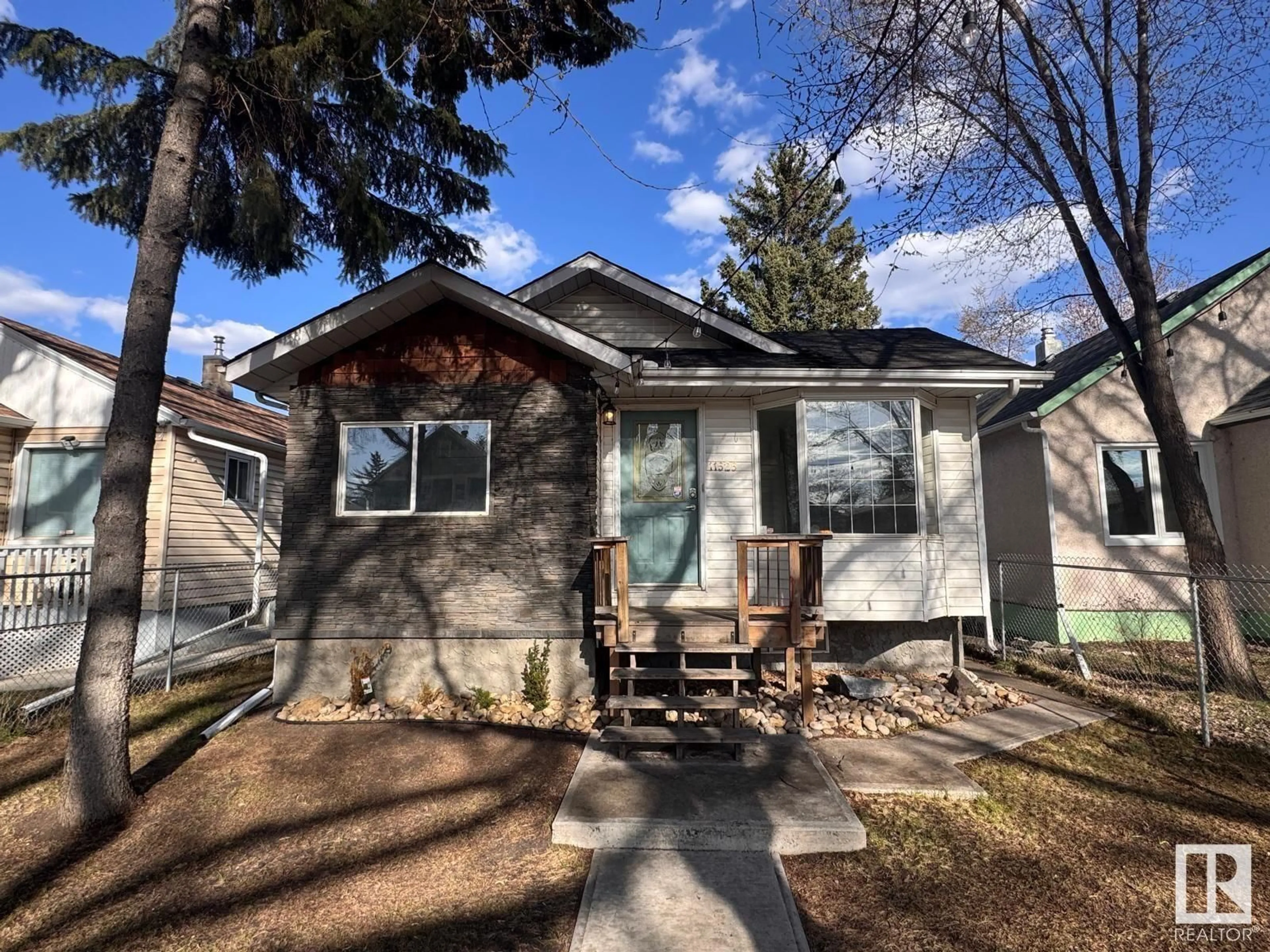 Home with vinyl exterior material, street for 11525 96 ST, Edmonton Alberta T6C3Y4
