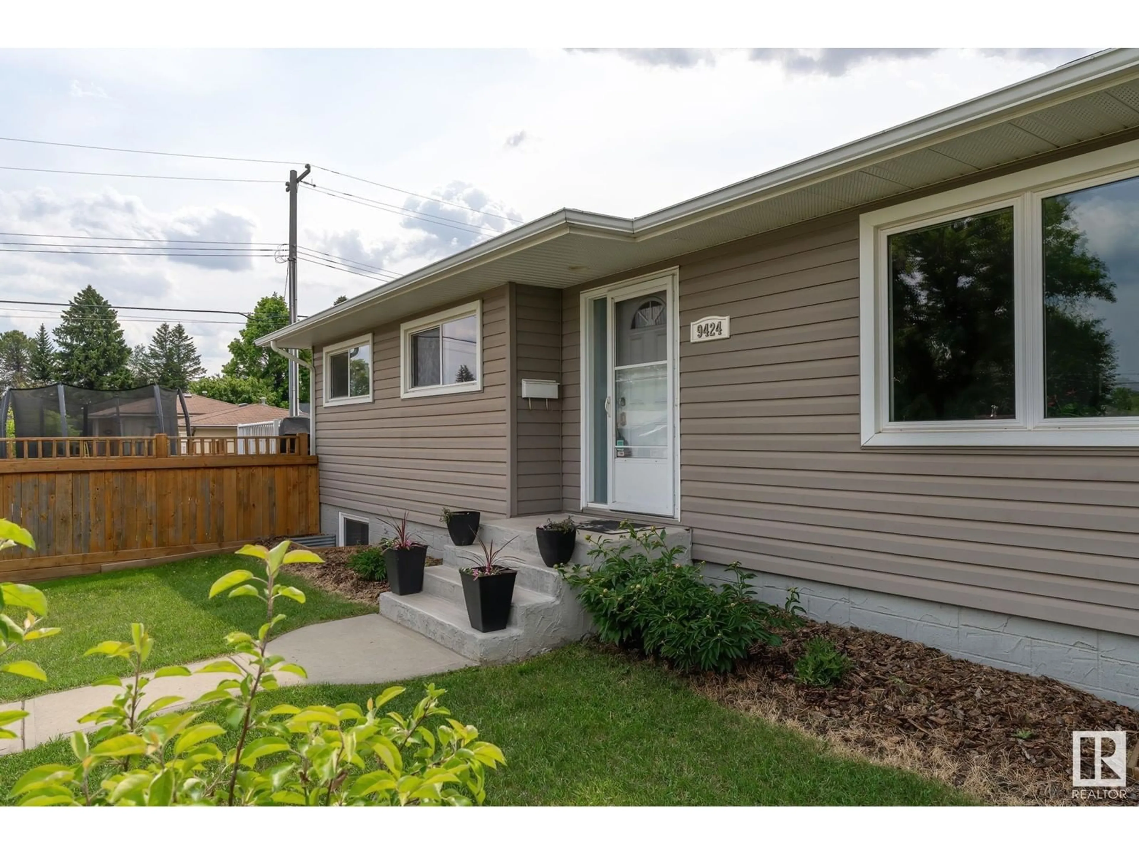 Home with vinyl exterior material, street for 9424 58 ST, Edmonton Alberta T6B1M2