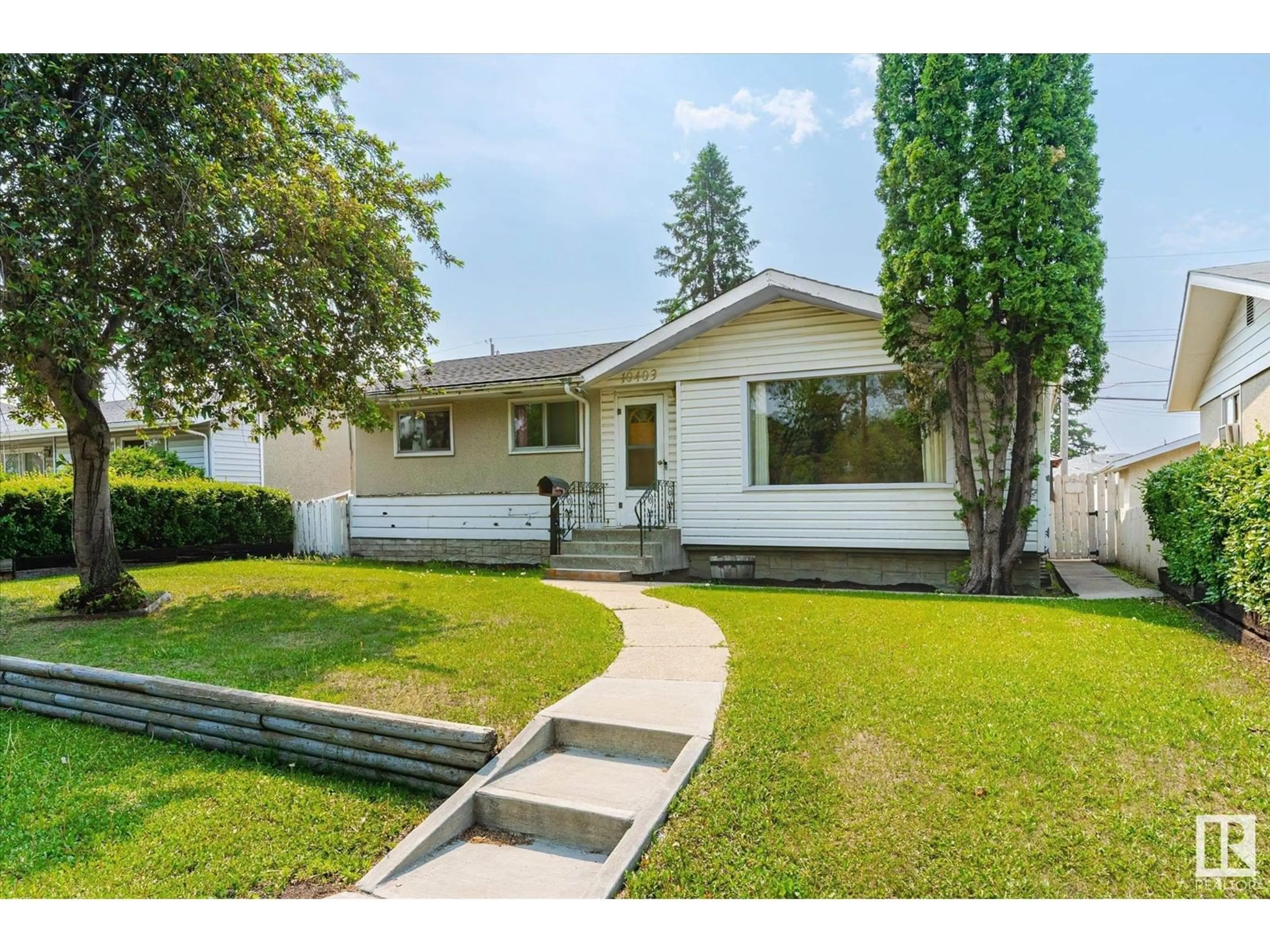 Home with vinyl exterior material, street for 10403 137 AV, Edmonton Alberta T6E1Y9