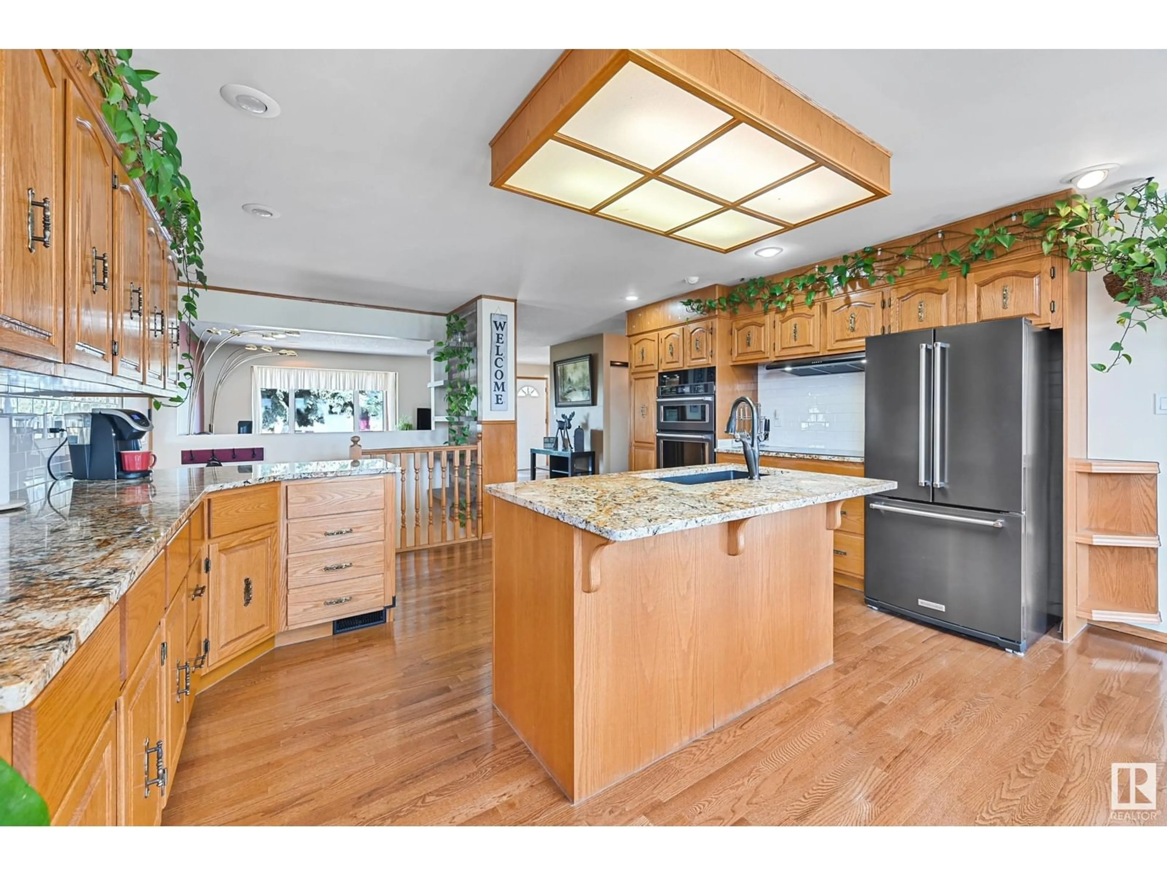 Open concept kitchen, wood/laminate floor for 16735 79A AV, Edmonton Alberta T5R3J4