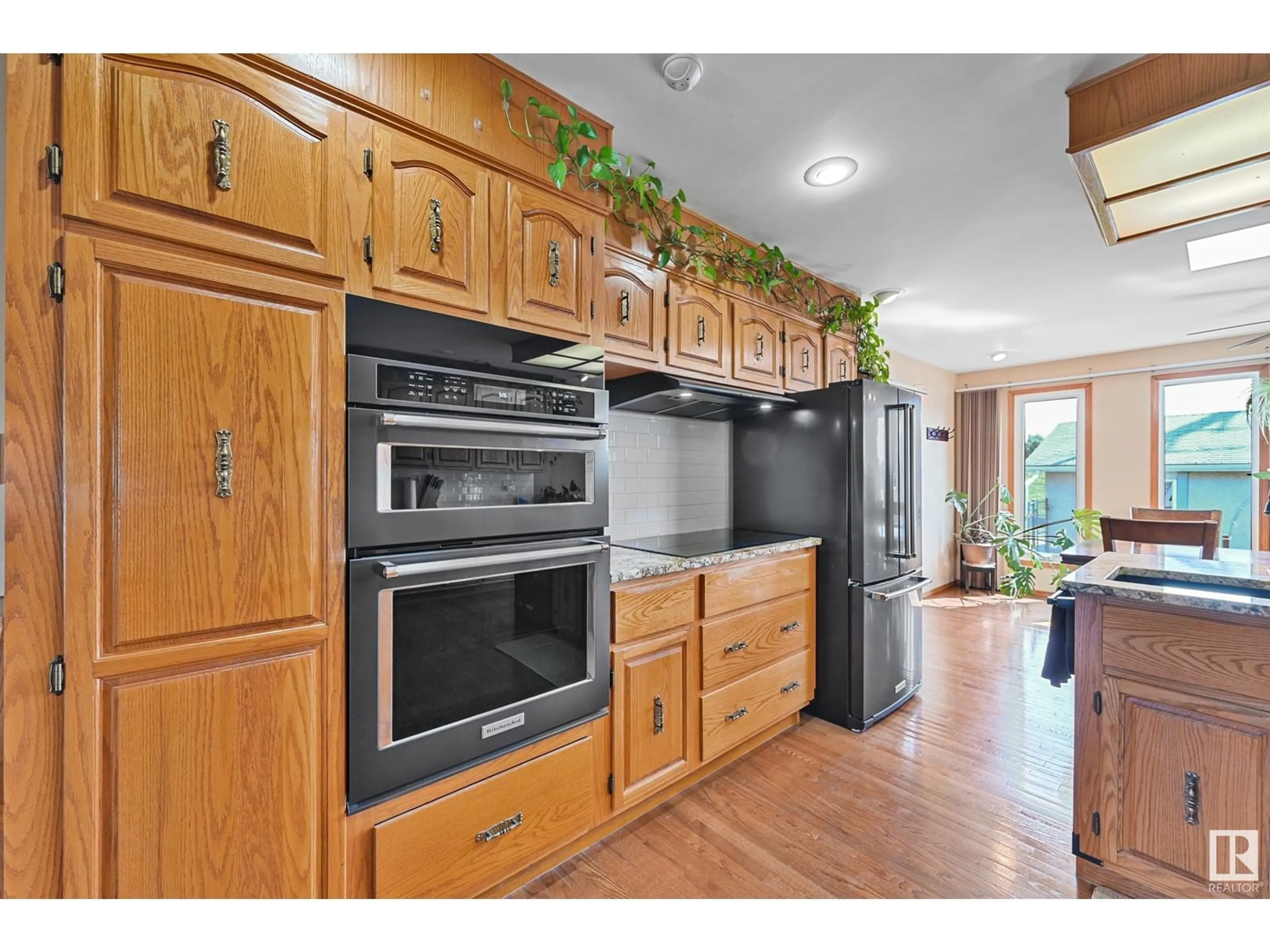 Open concept kitchen, wood/laminate floor for 16735 79A AV, Edmonton Alberta T5R3J4