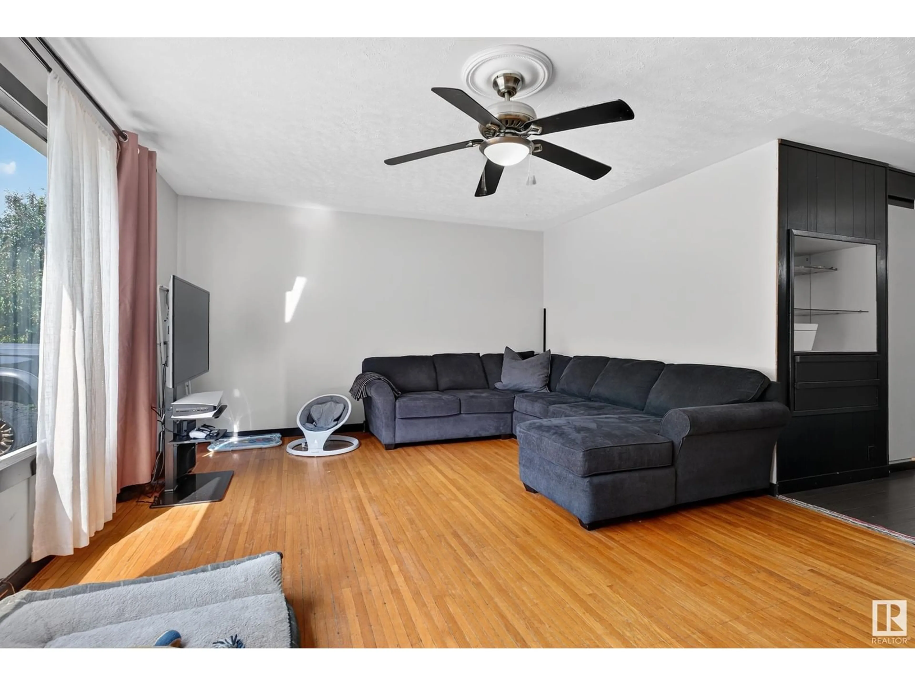 Living room with furniture, wood/laminate floor for 3620 115 AV, Edmonton Alberta T5W0T9