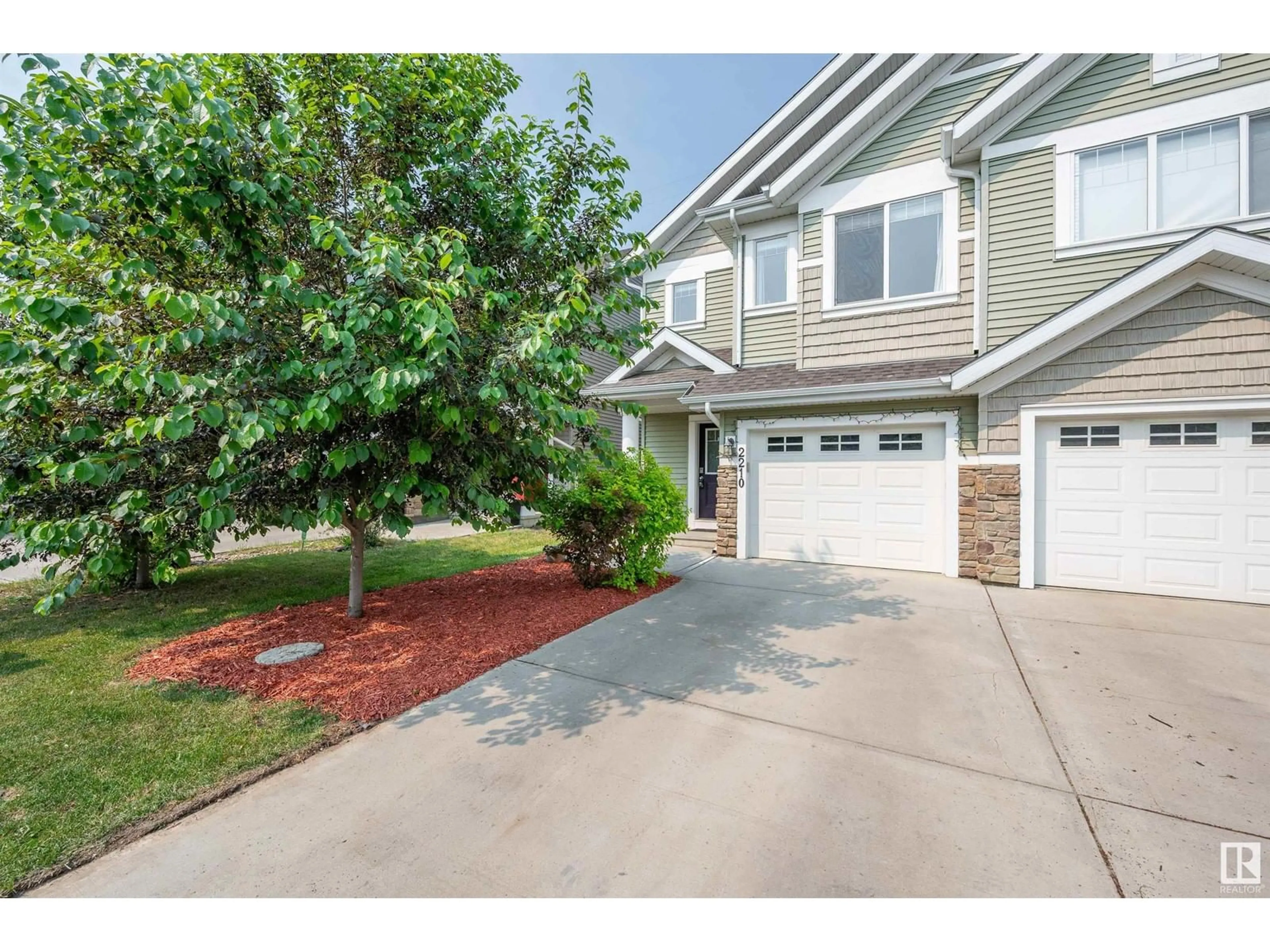 Home with vinyl exterior material, street for 2210 86 ST, Edmonton Alberta T6X2G2