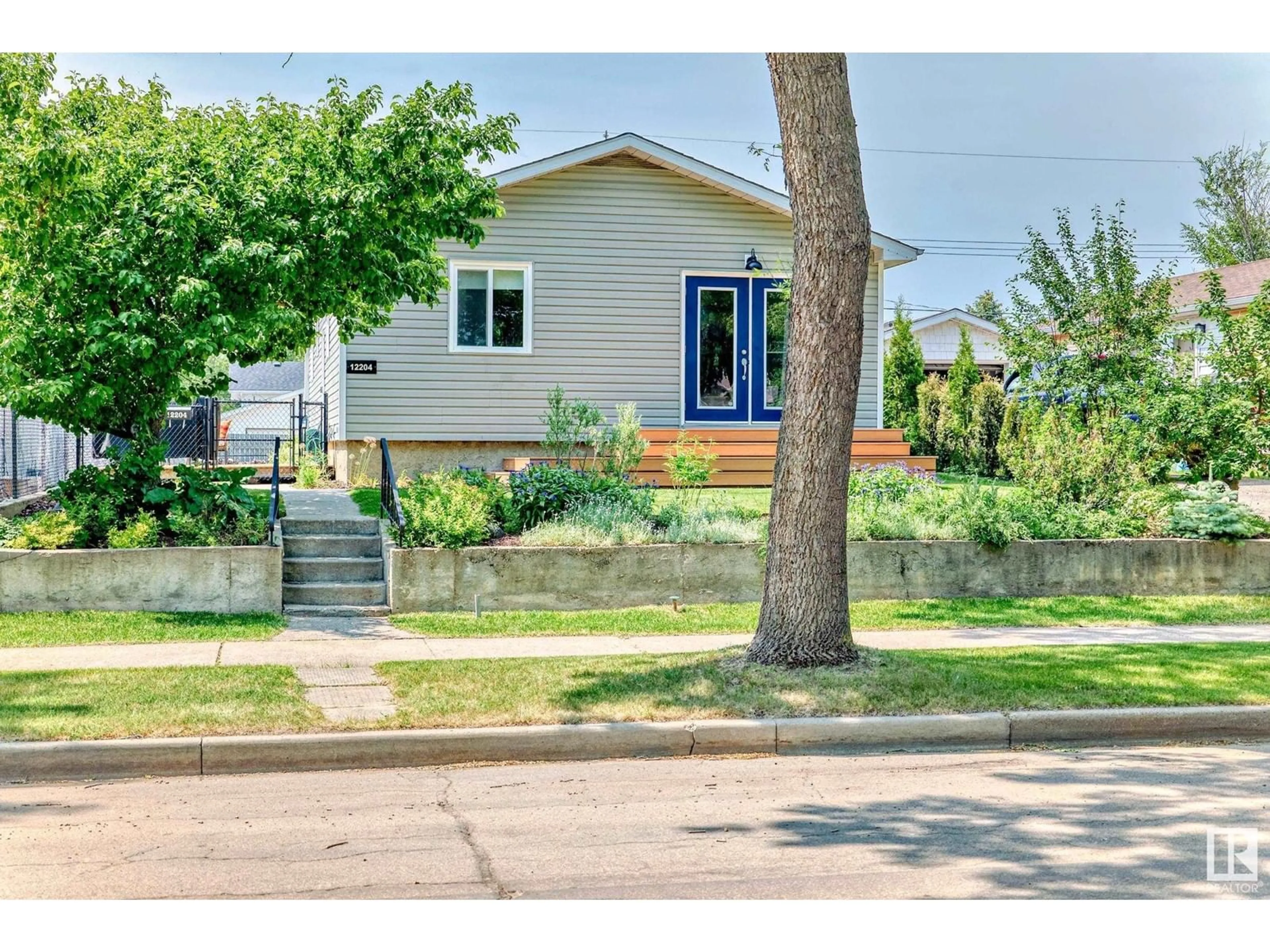 Home with vinyl exterior material, street for 12204 43 ST, Edmonton Alberta T5W2R3