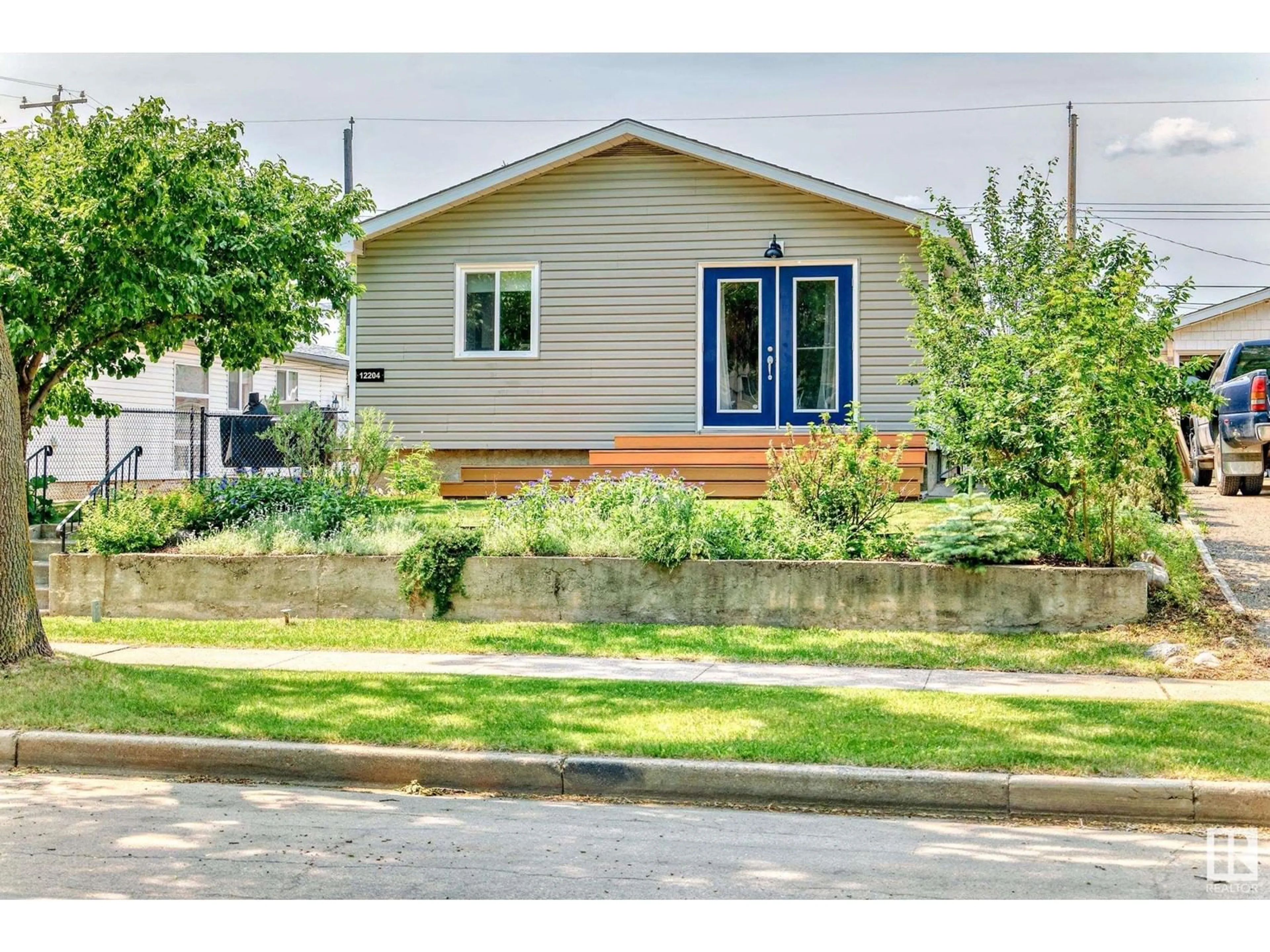 Home with vinyl exterior material, street for 12204 43 ST, Edmonton Alberta T5W2R3