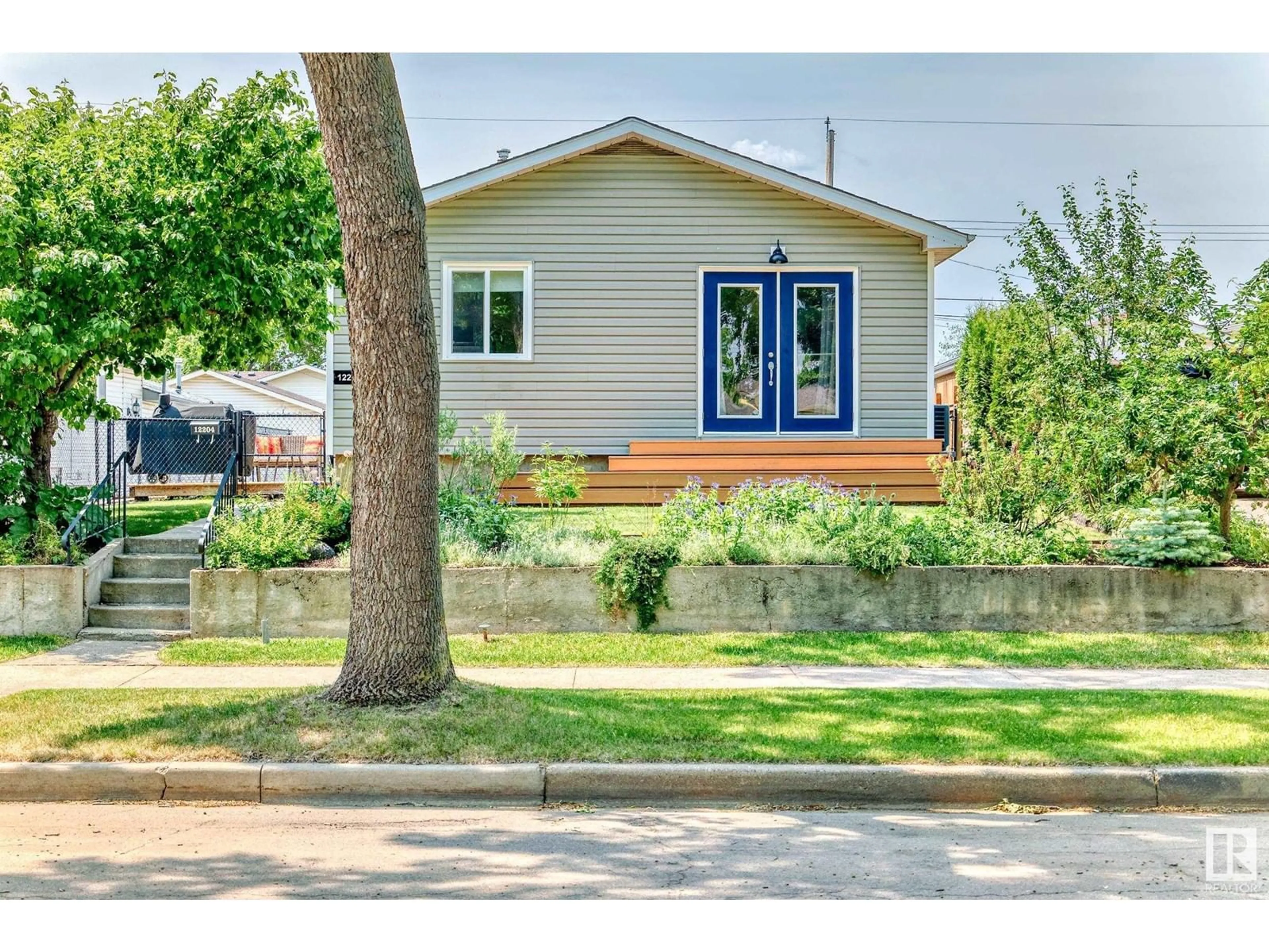 Home with vinyl exterior material, street for 12204 43 ST, Edmonton Alberta T5W2R3