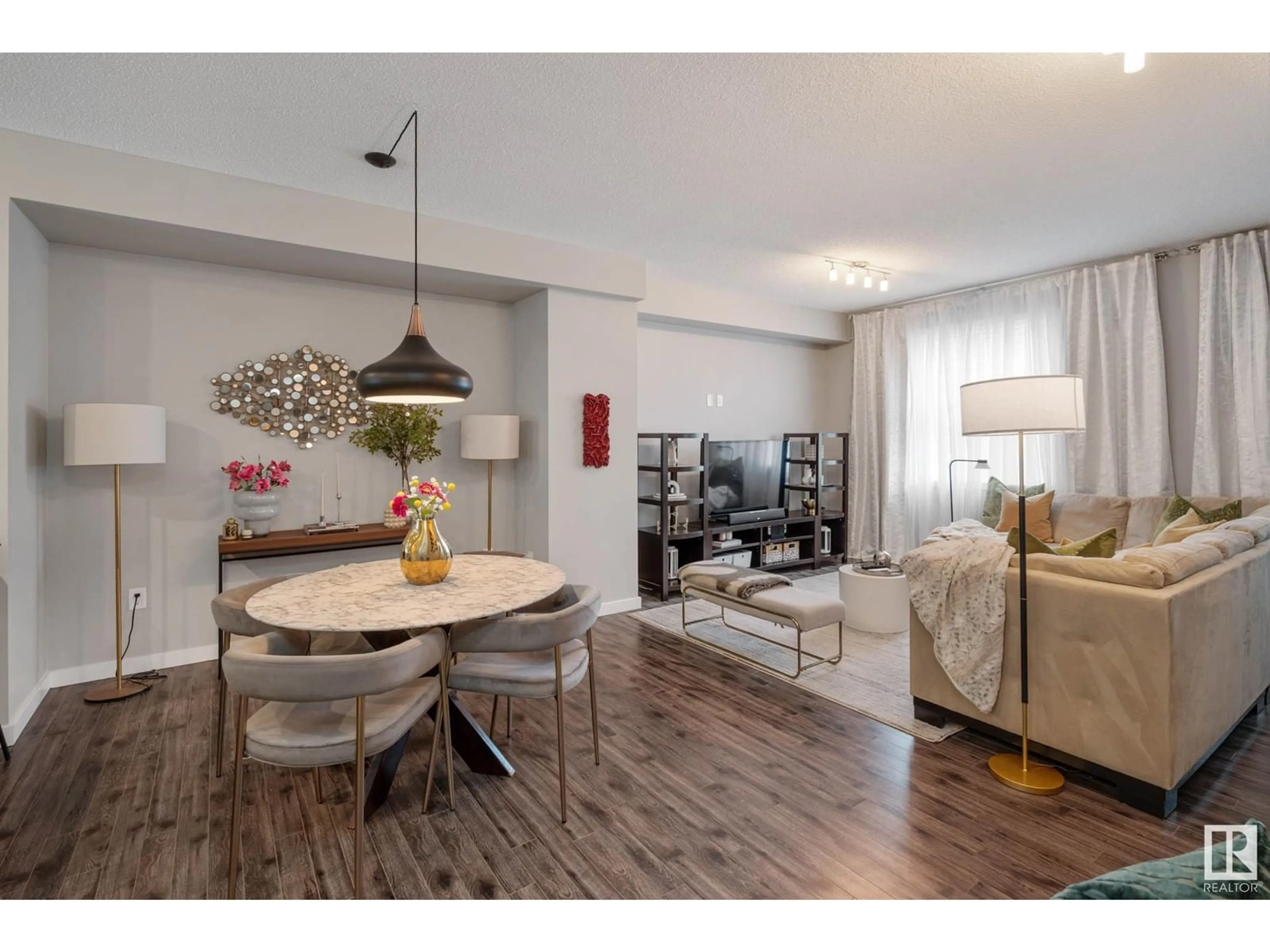 Living room with furniture, wood/laminate floor for #71 - 2803 JAMES MOWATT TR, Edmonton Alberta T6W2P5