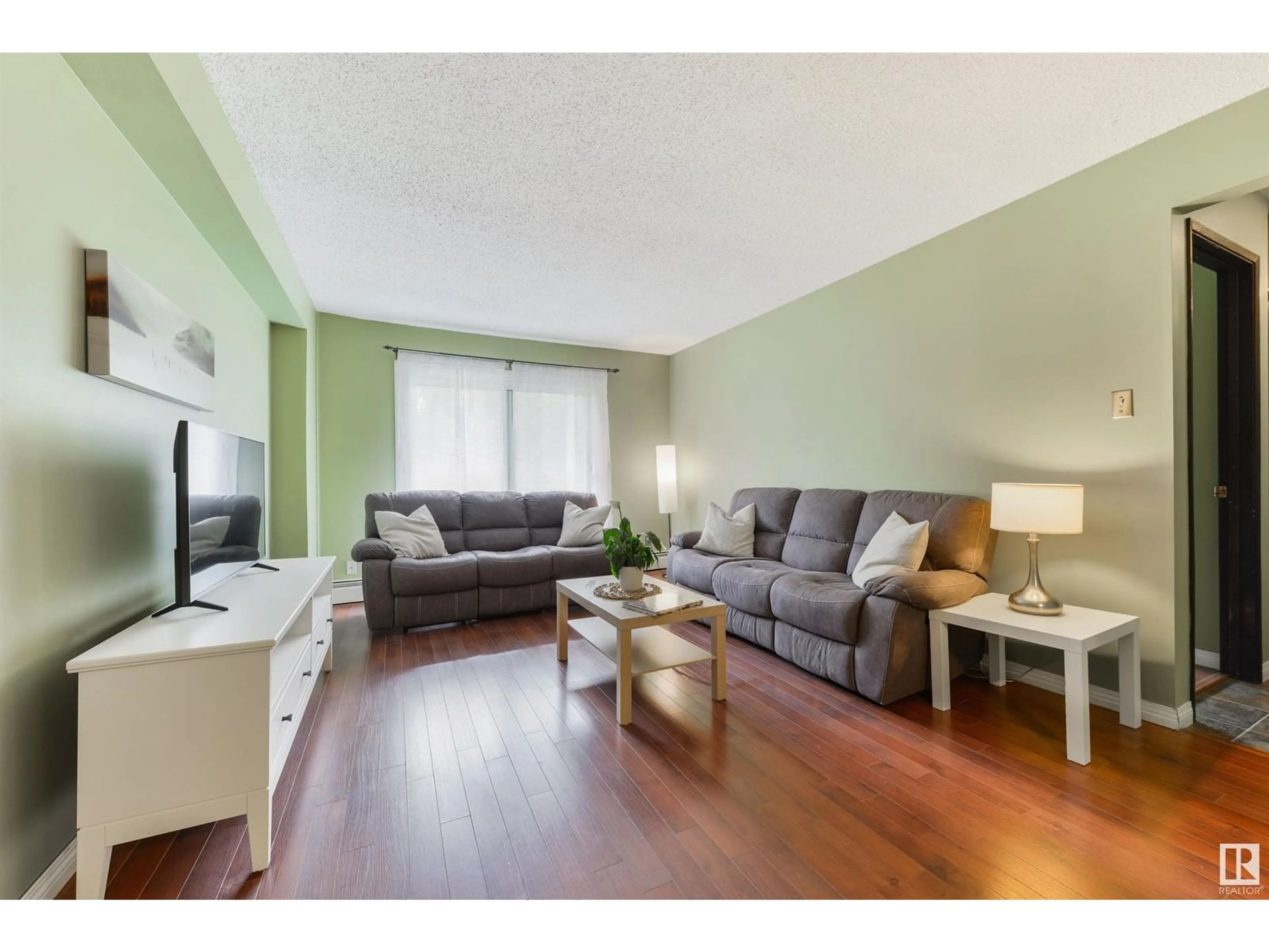Living room with furniture, wood/laminate floor for 10250 - 310 116 ST, Edmonton Alberta T5K1W4