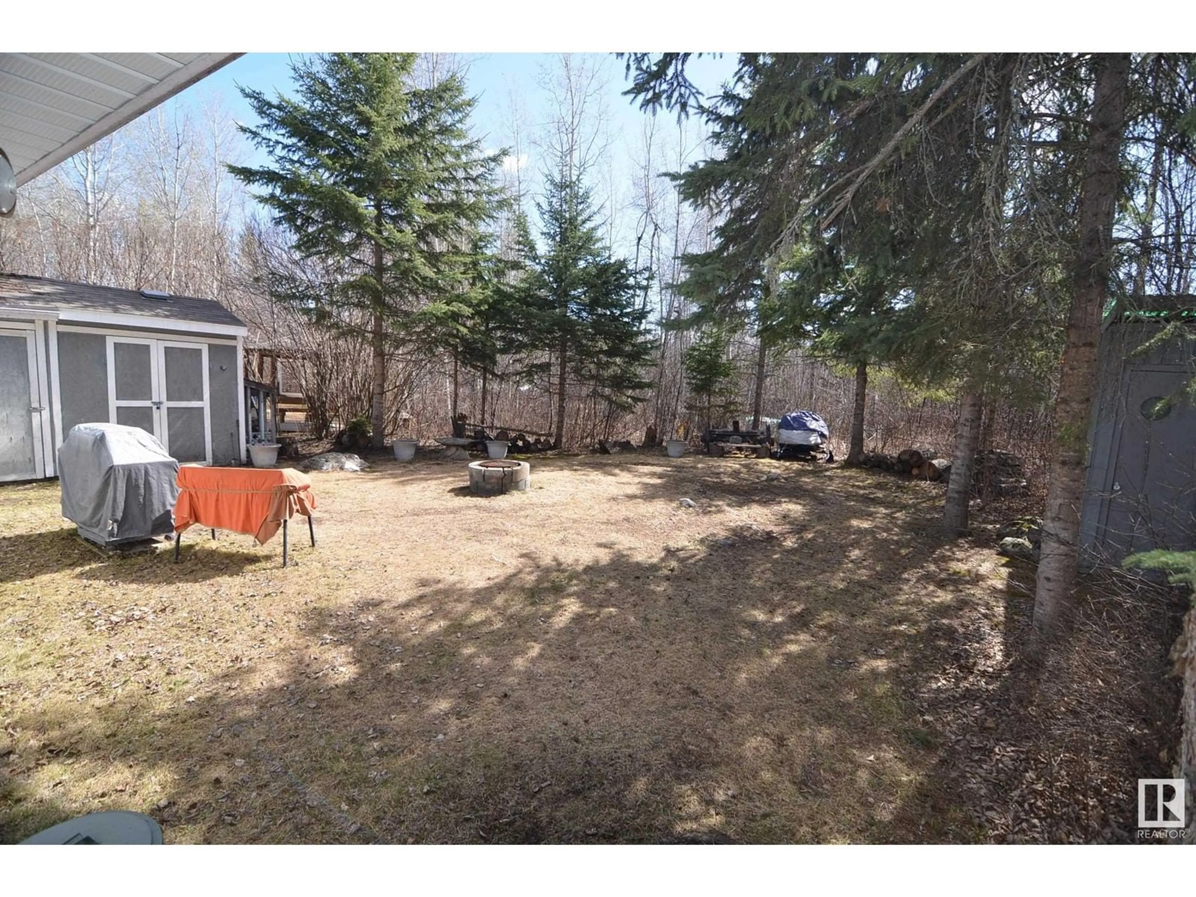 A pic from outside/outdoor area/front of a property/back of a property/a pic from drone, forest/trees view for 110 - 5415 TWP RD 594, Rural Barrhead County Alberta T7N1N3