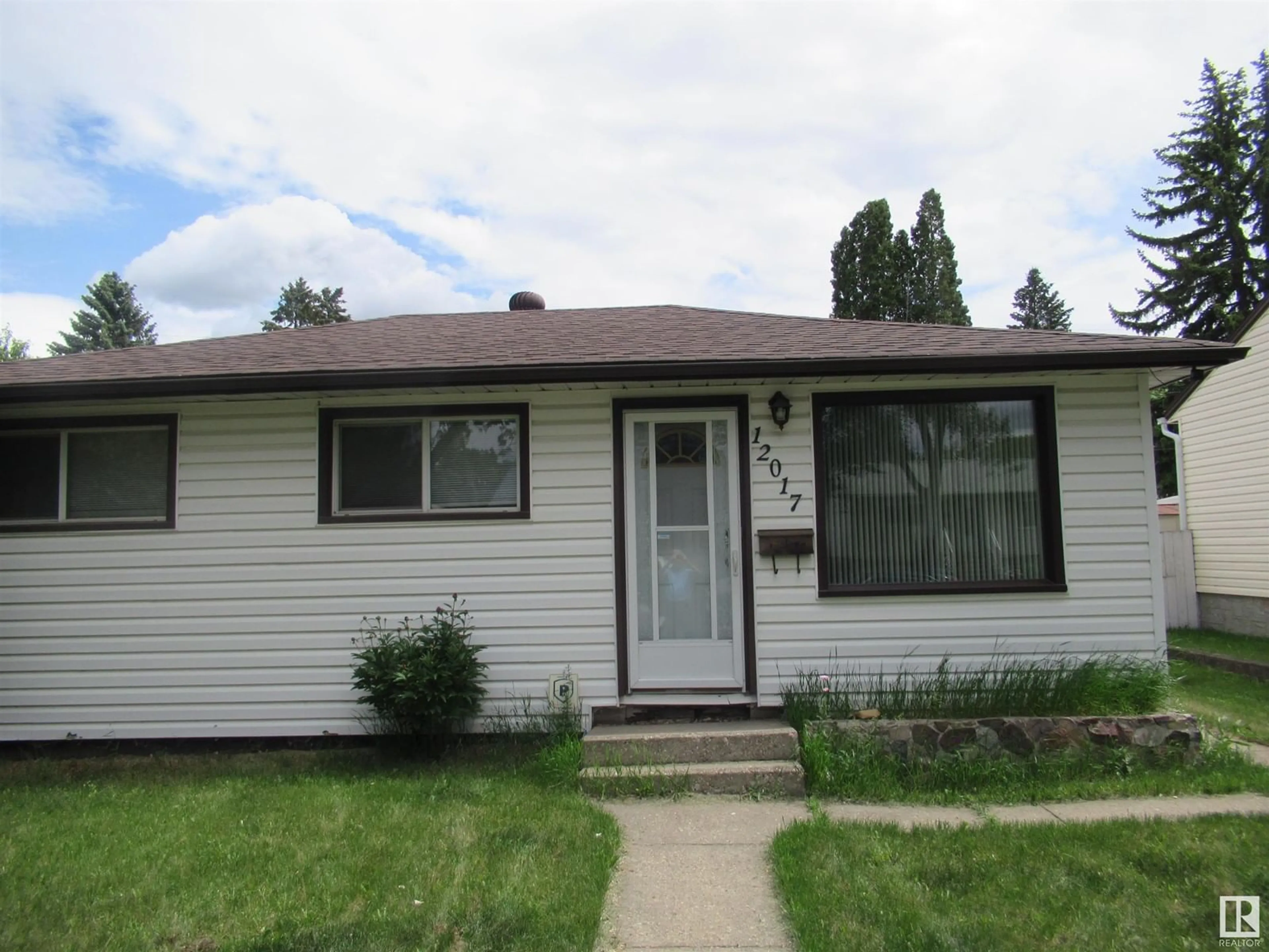Home with vinyl exterior material, street for 12017 45 ST, Edmonton Alberta T5W2T7