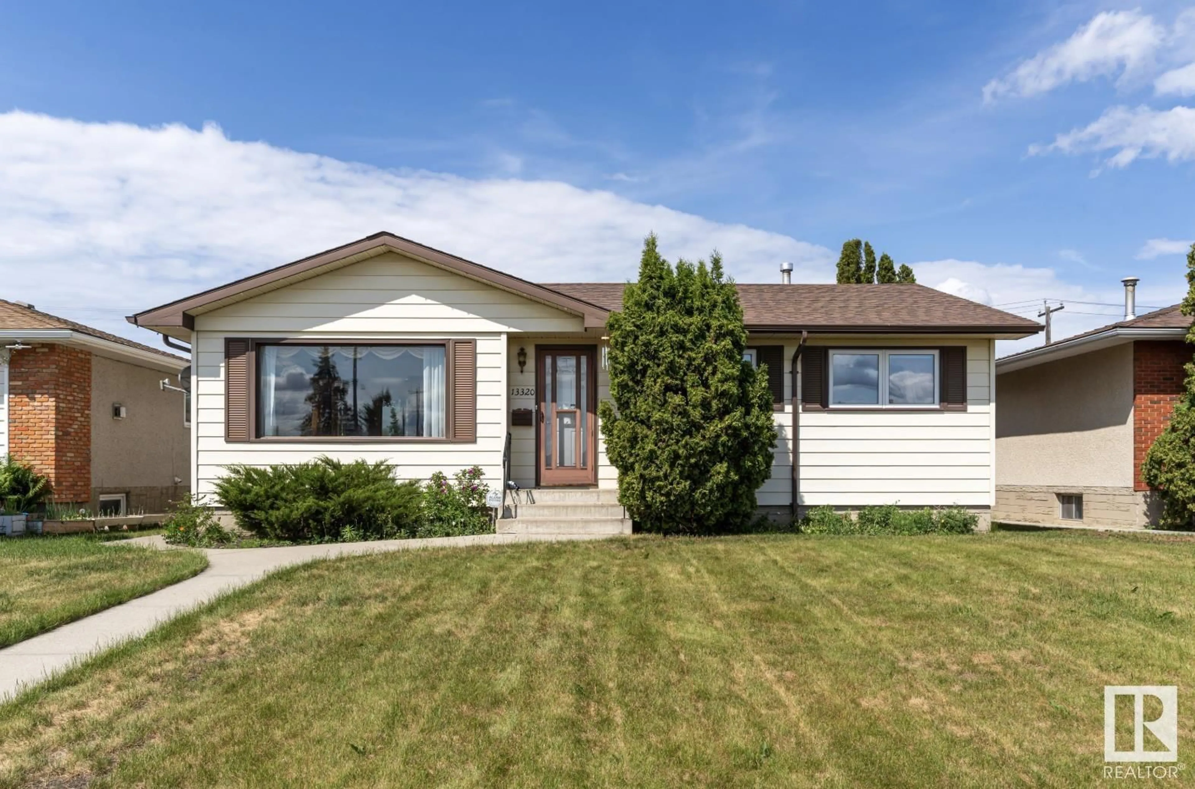 Home with vinyl exterior material, street for 13320 94 STREET, Edmonton Alberta T5E3V8