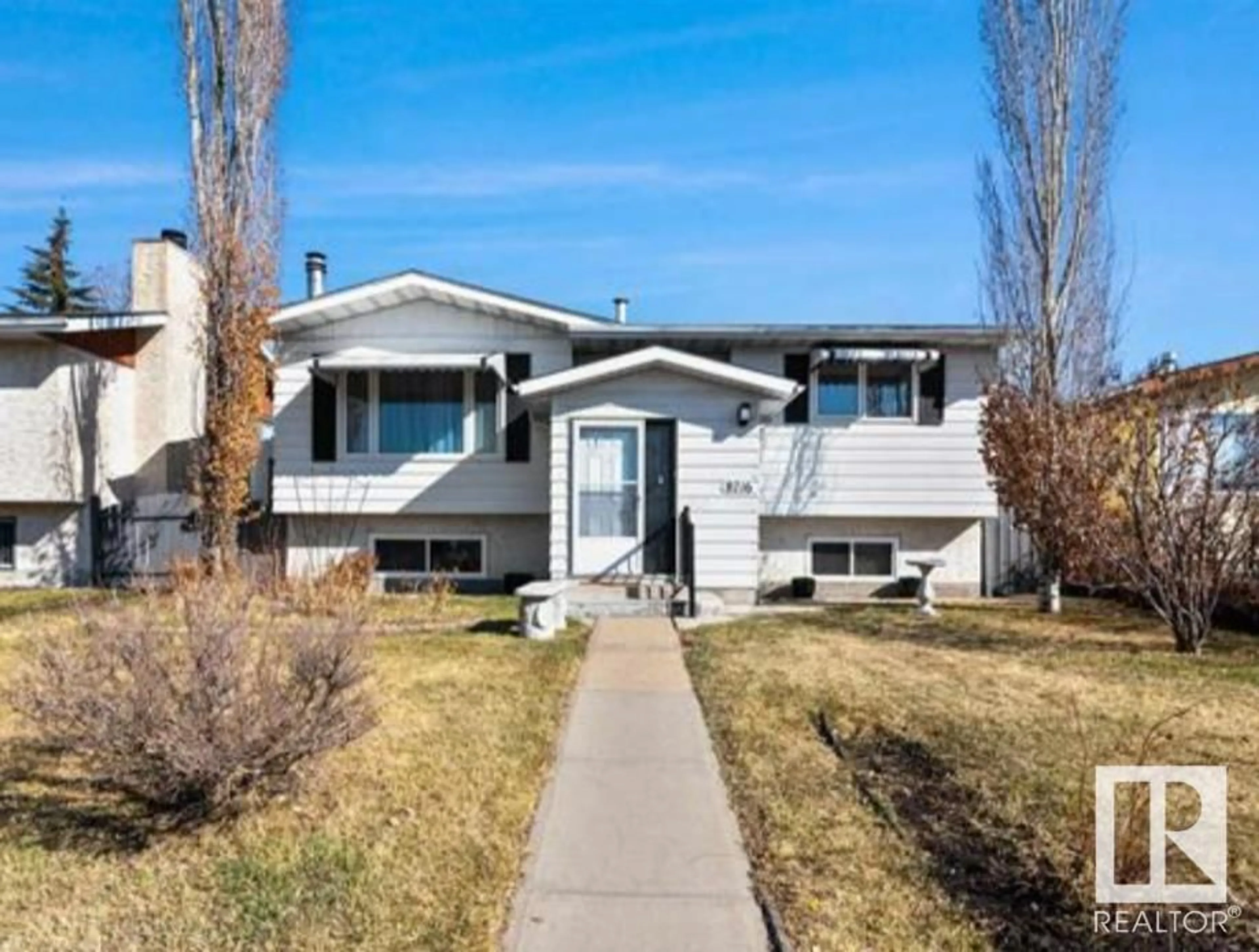 Home with vinyl exterior material, street for 8716 29 AV, Edmonton Alberta T6K2X6
