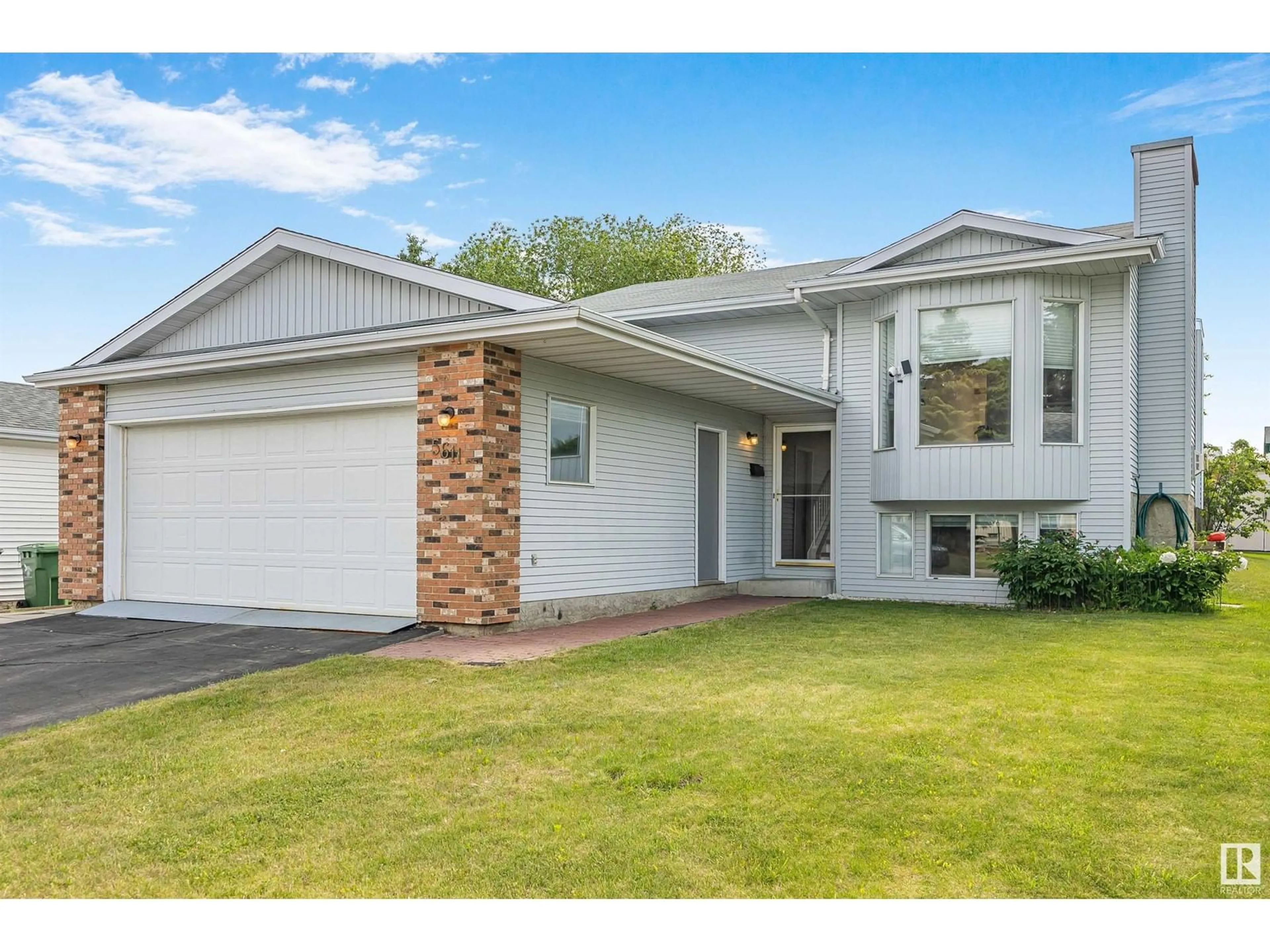 Home with vinyl exterior material, street for 5611 56 ST, Beaumont Alberta T4X1A6