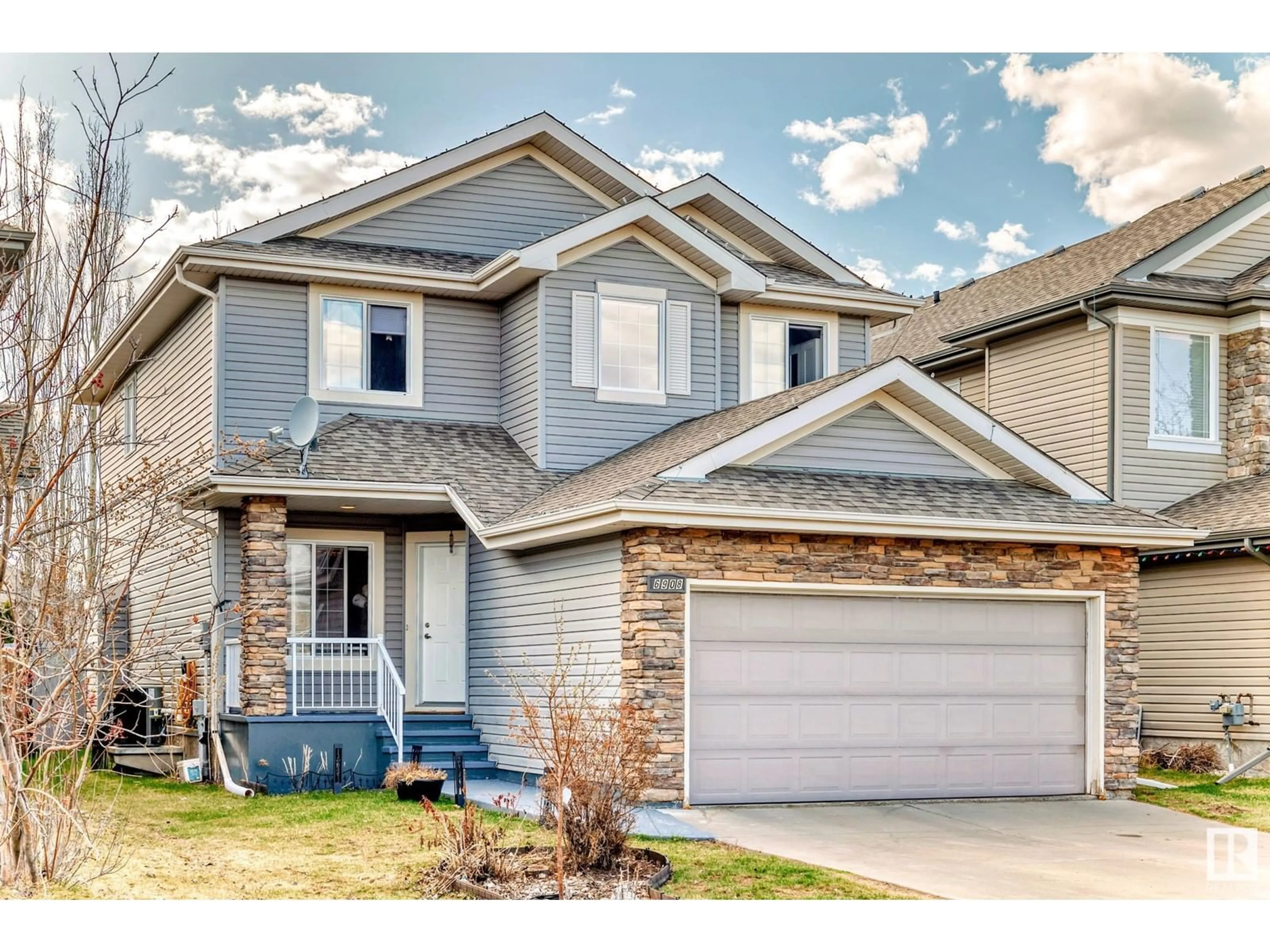 Home with vinyl exterior material, street for 6908 STROM LN, Edmonton Alberta T6R0G3
