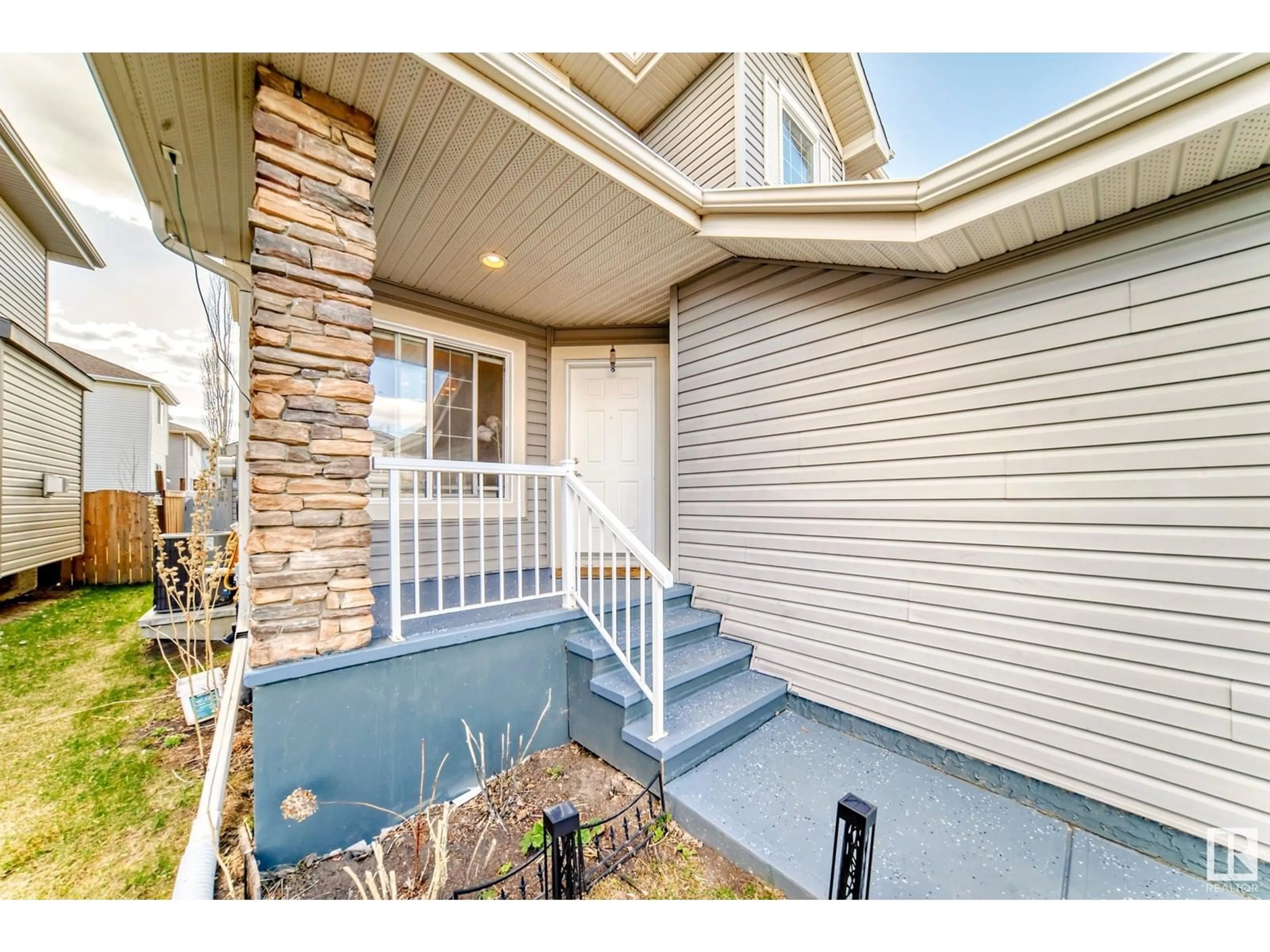 Home with vinyl exterior material, street for 6908 STROM LN, Edmonton Alberta T6R0G3