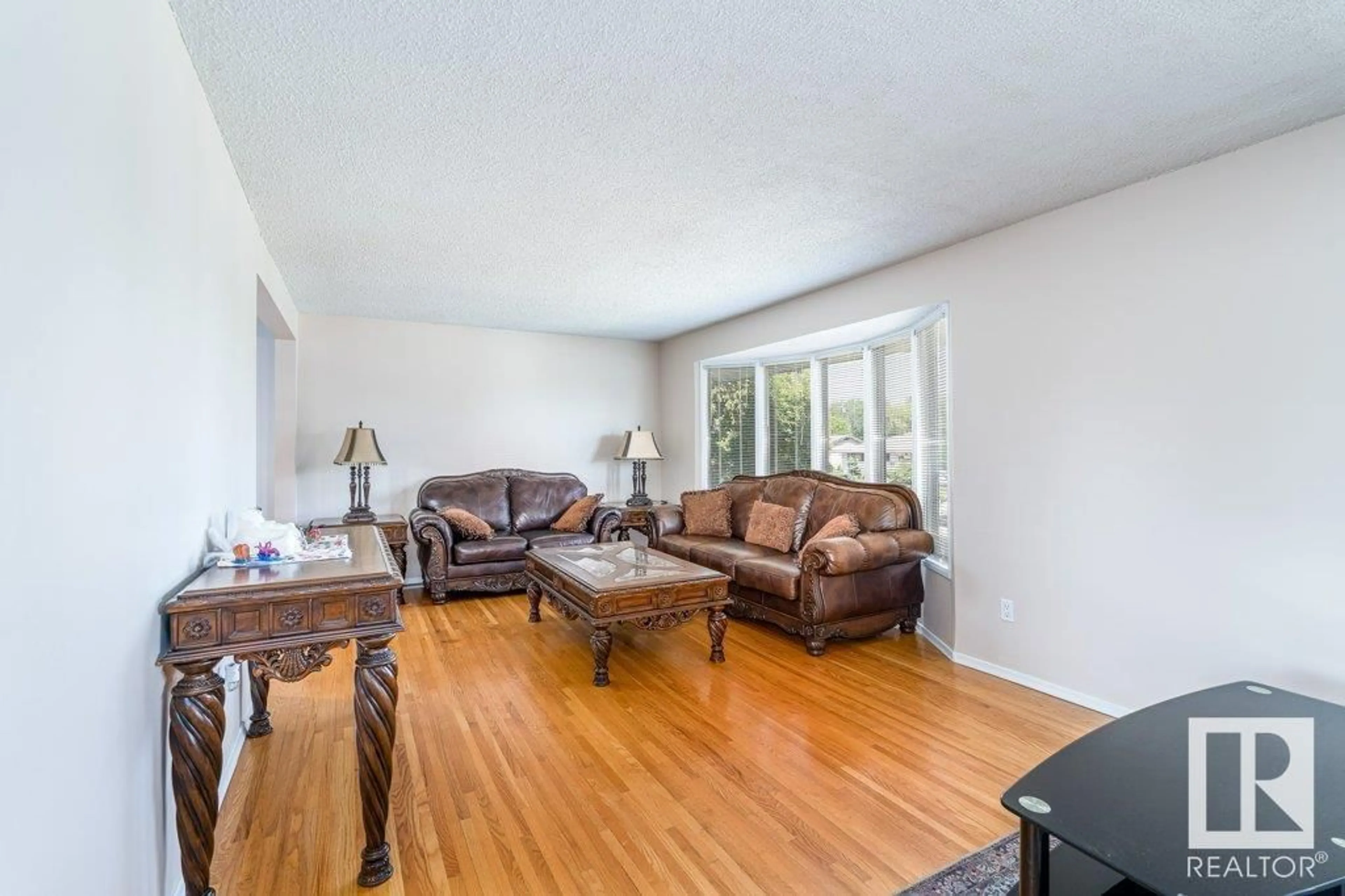 Living room with furniture, wood/laminate floor for 13803 133 AV, Edmonton Alberta T5L3T3