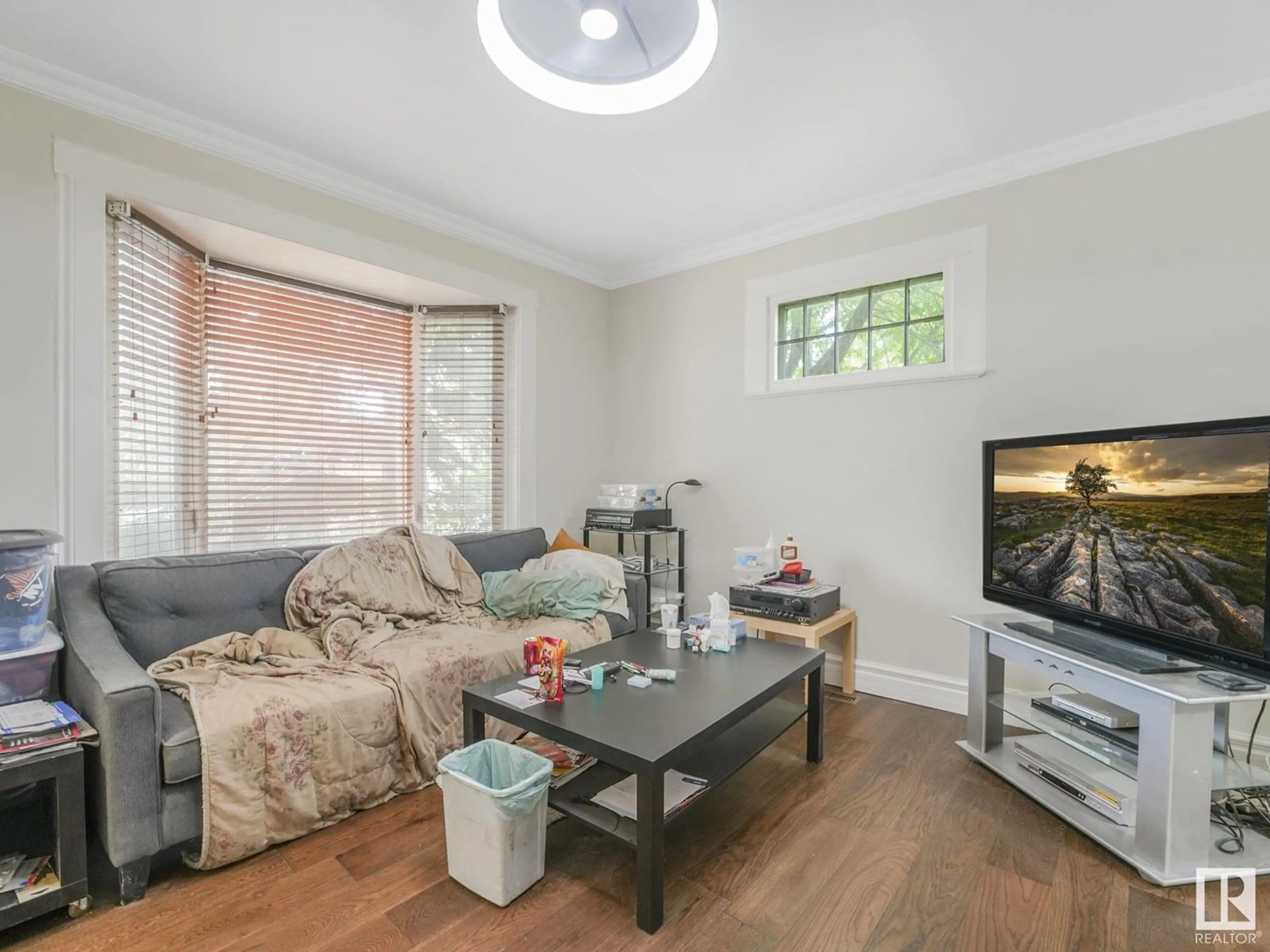 Living room with furniture, wood/laminate floor for NW - 10713 93 ST, Edmonton Alberta T5H1Y2