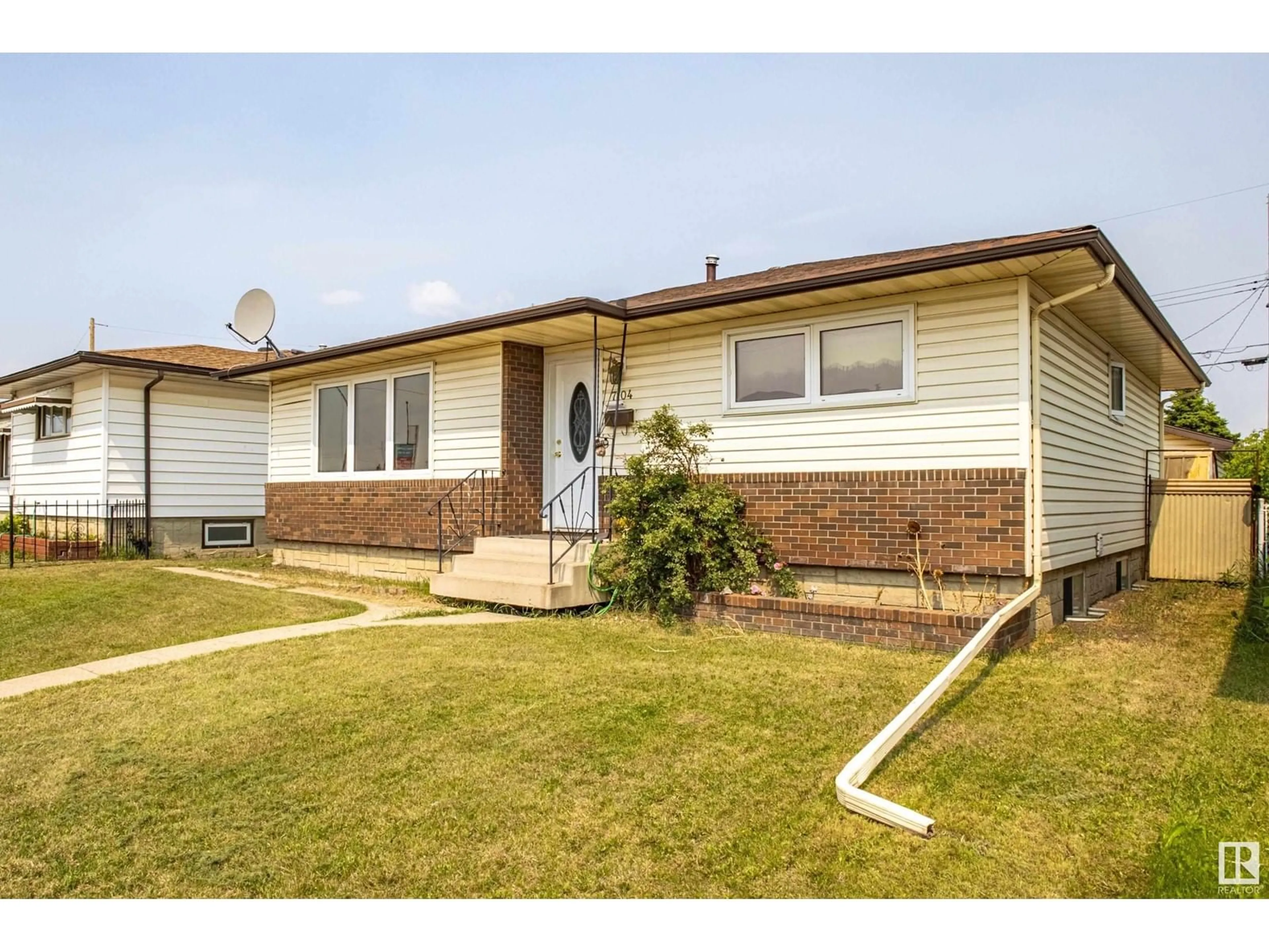 Home with brick exterior material, street for 7104 132 AV NW, Edmonton Alberta T5C2A6