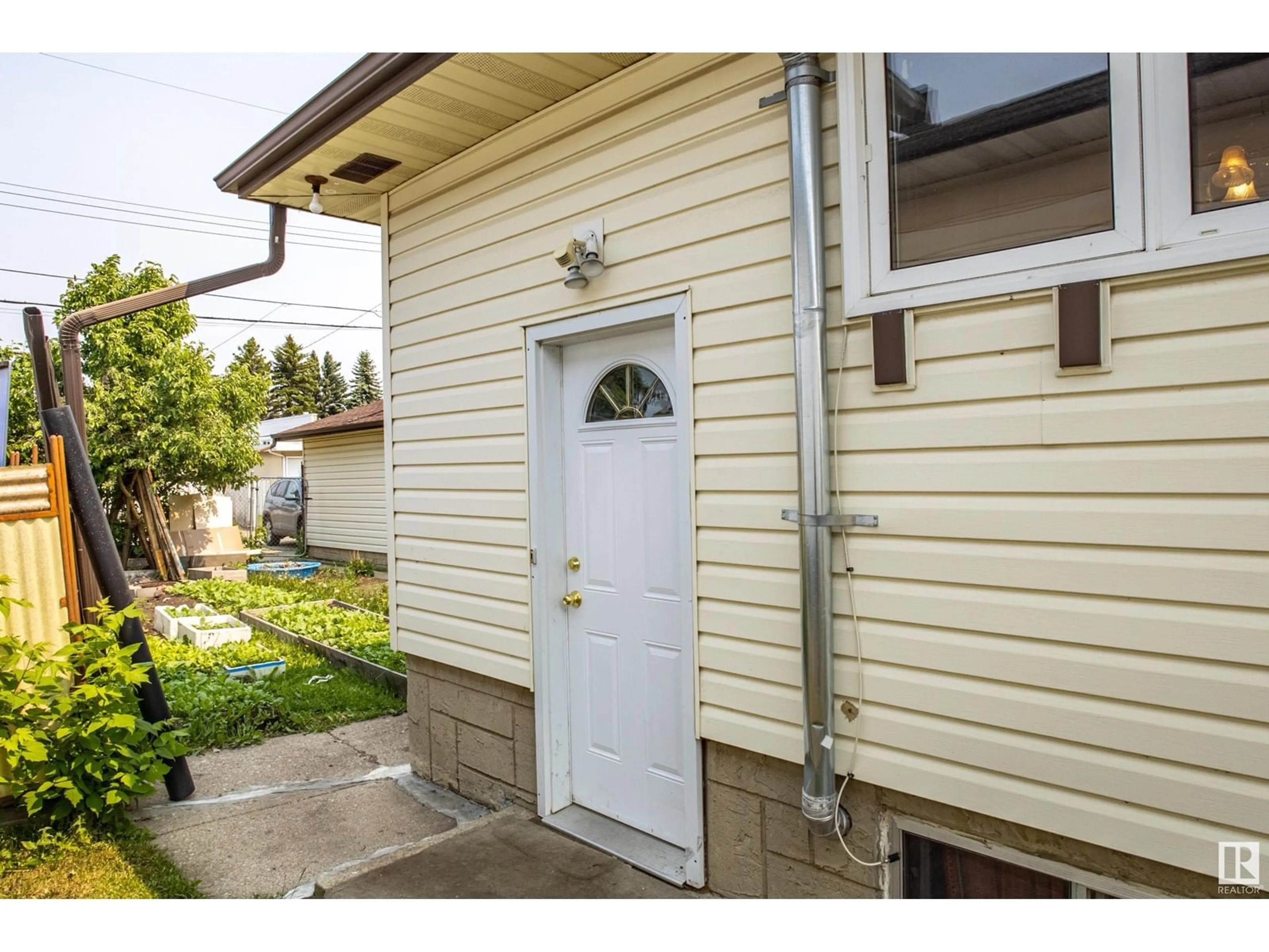 Home with vinyl exterior material, street for 7104 132 AV NW, Edmonton Alberta T5C2A6