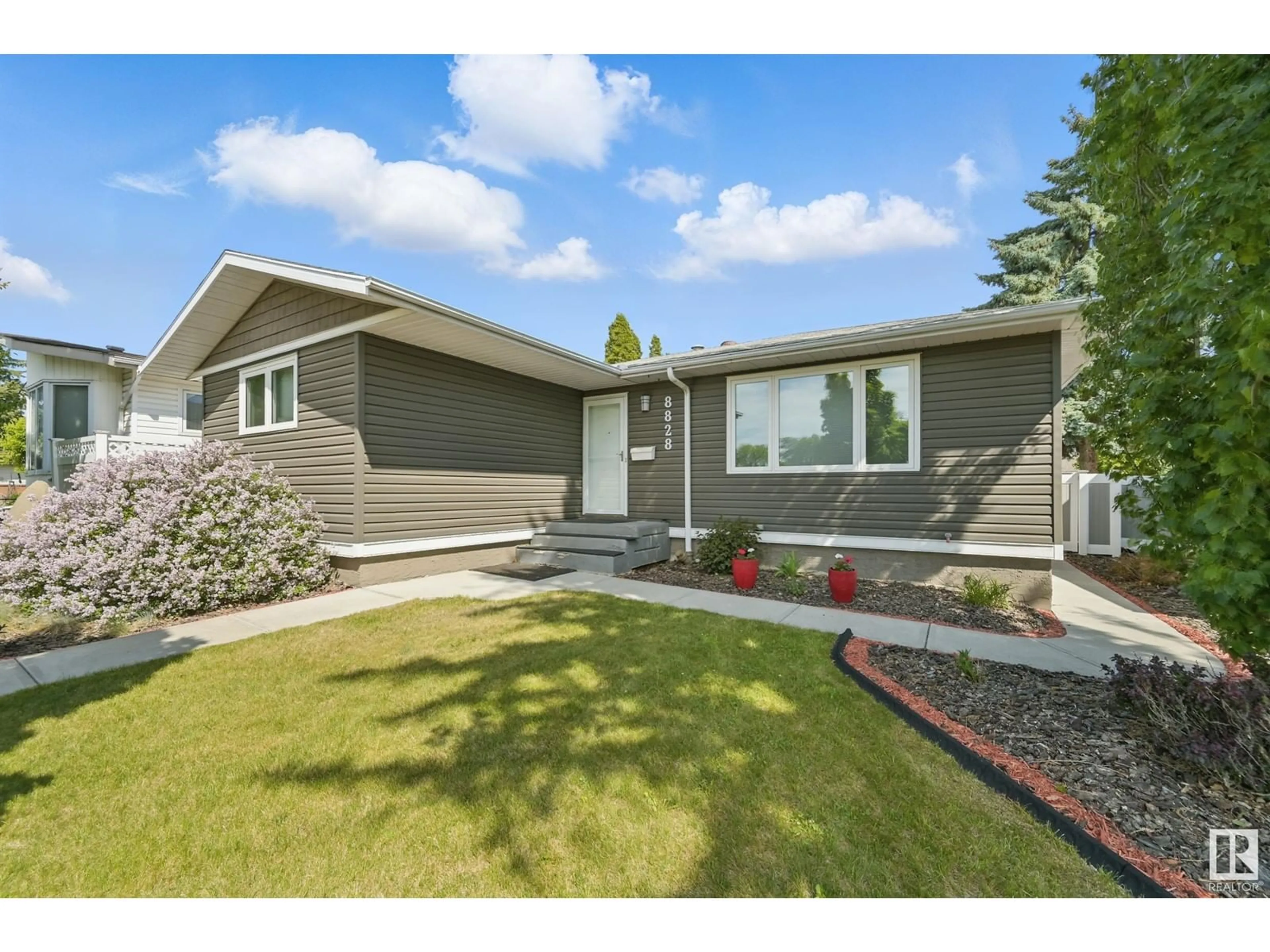 Home with vinyl exterior material, street for 8828 135 AV, Edmonton Alberta T5E1N3