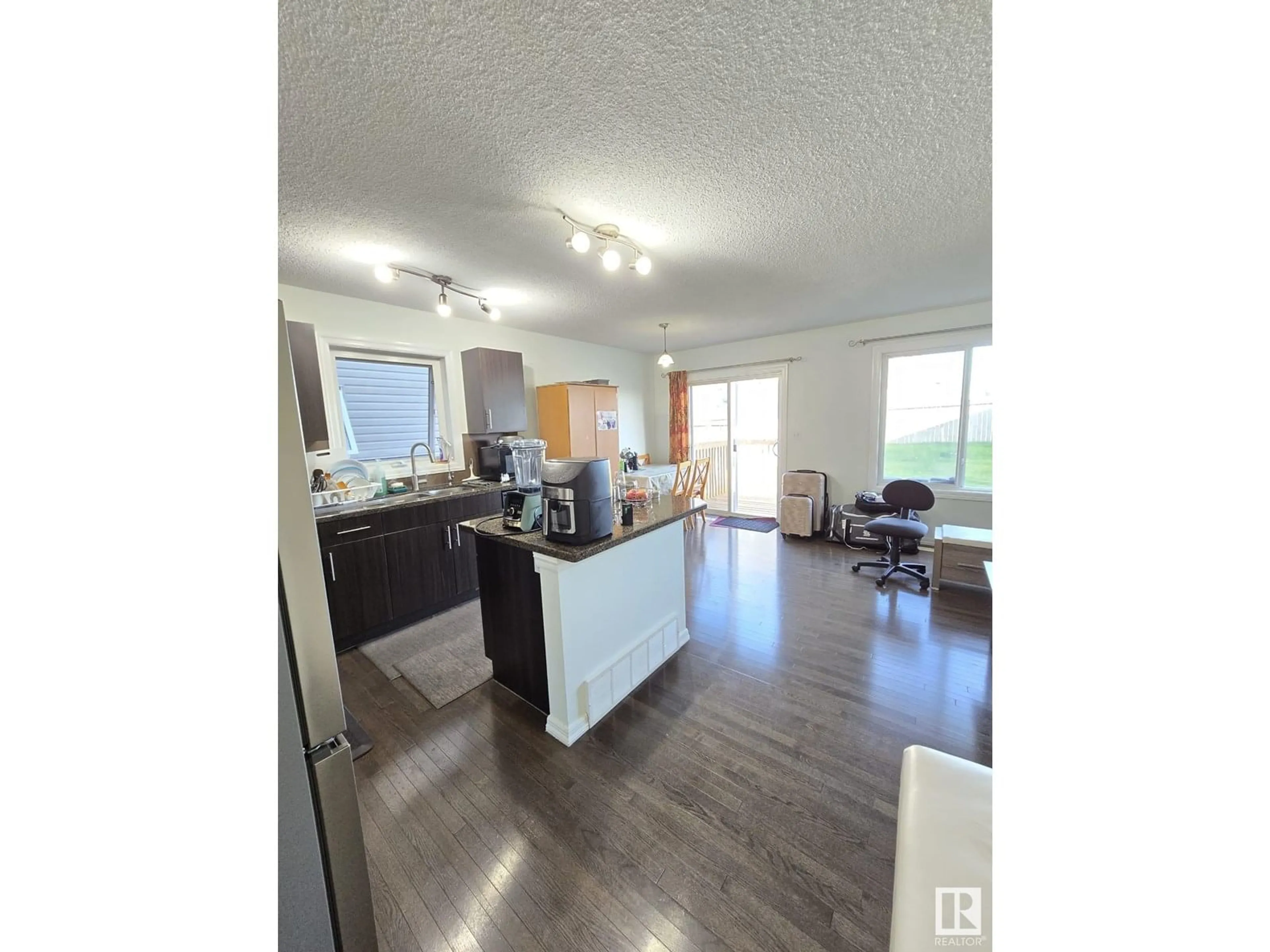 Open concept kitchen, wood/laminate floor for 2813 18A AV, Edmonton Alberta T6T0N8
