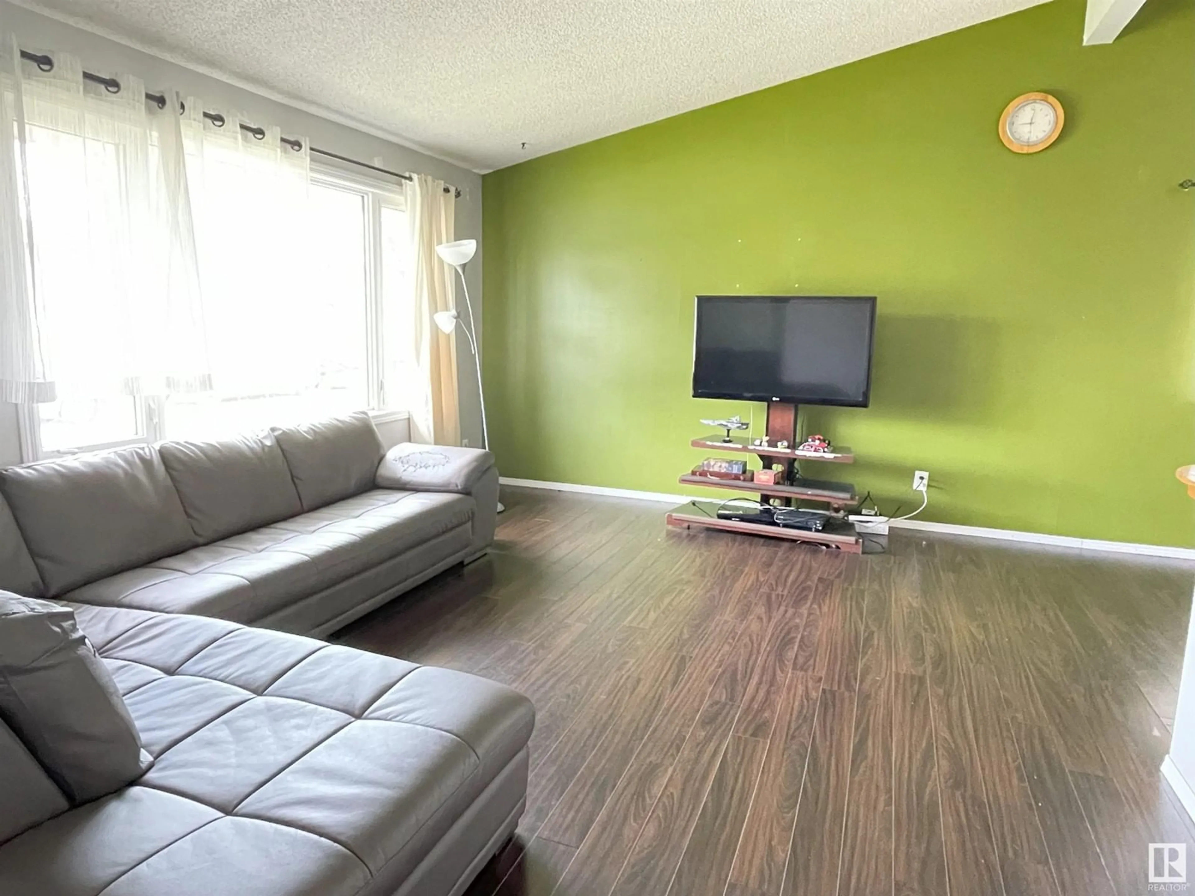 Living room with furniture, wood/laminate floor for 16103 87A AV NW, Edmonton Alberta T5R4H6