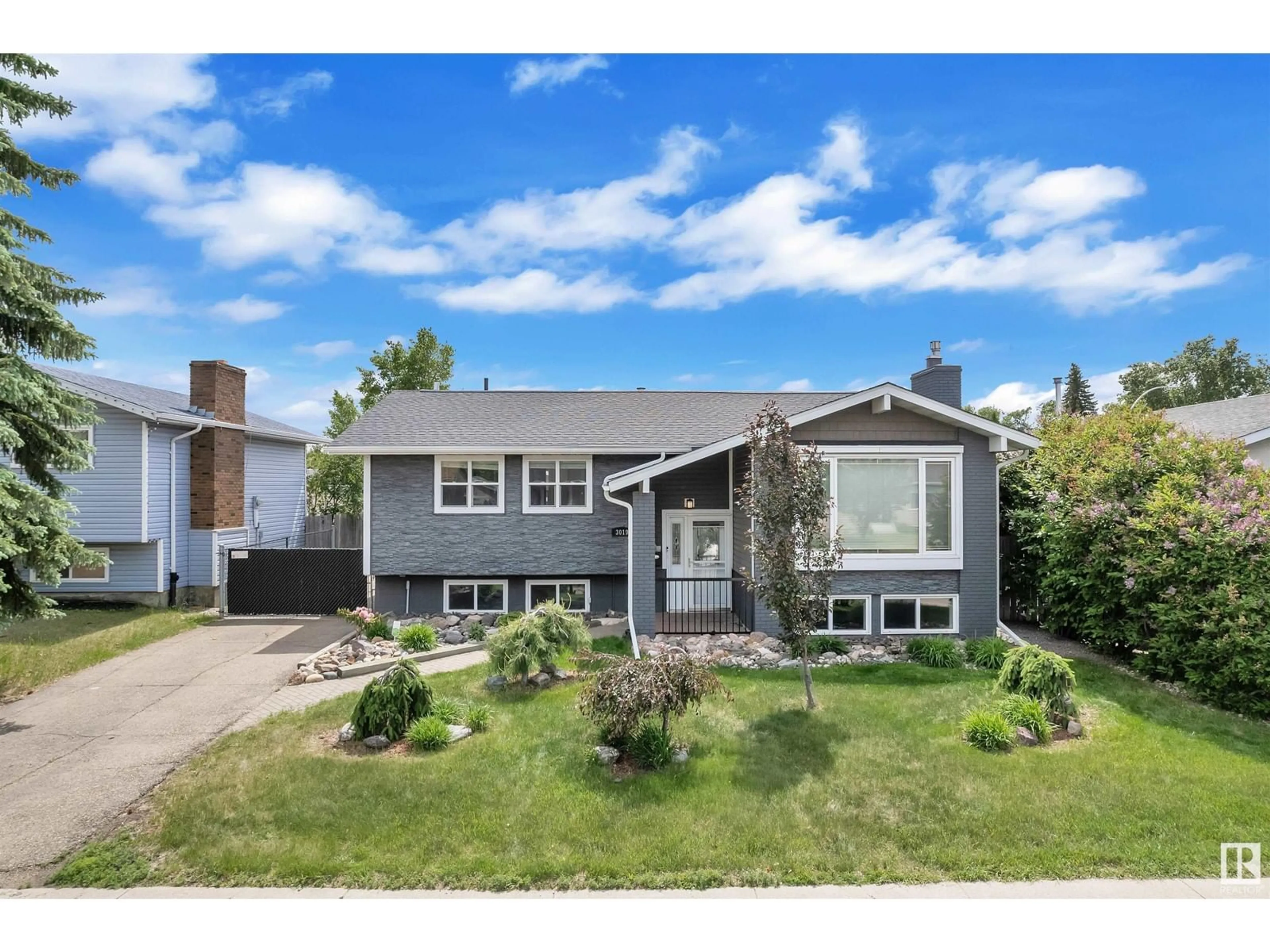 Home with vinyl exterior material, street for 3019 133 AV, Edmonton Alberta T5A2Z4