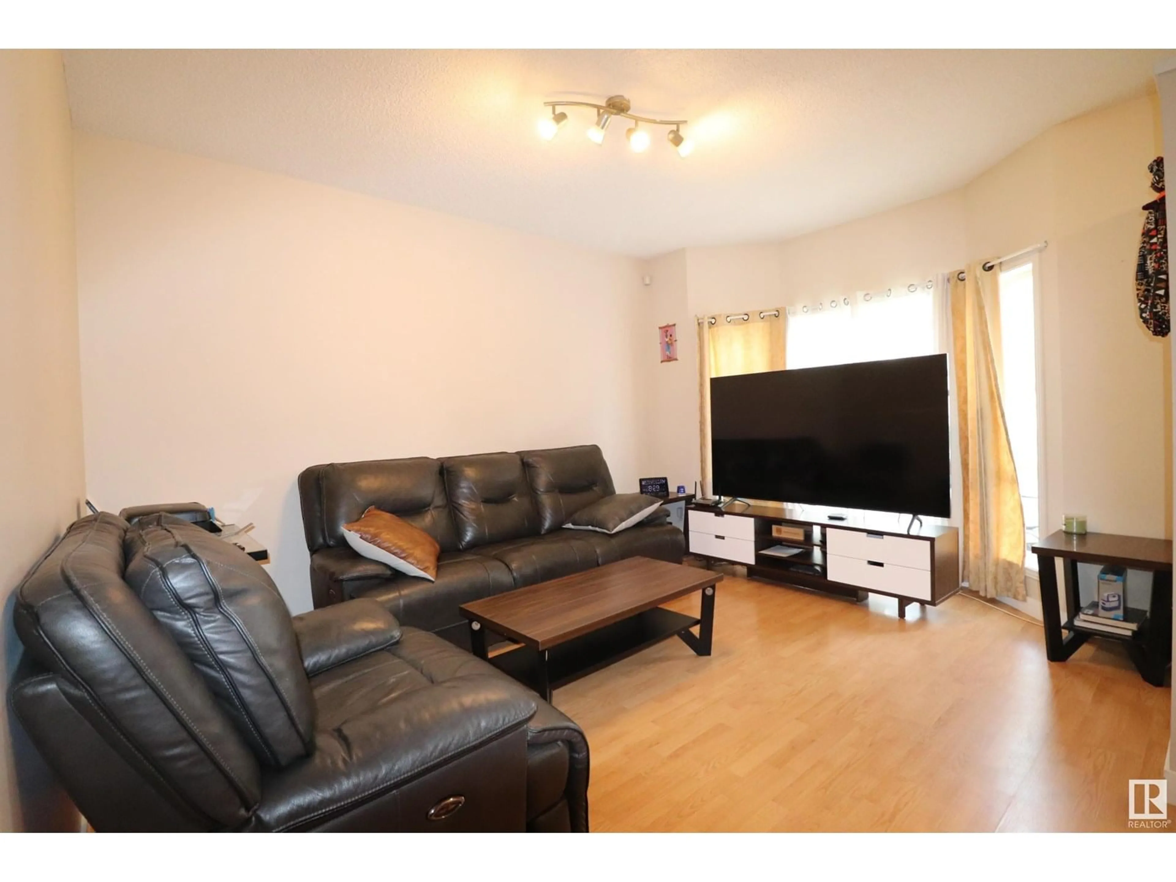 Living room with furniture, wood/laminate floor for 47 - 16728 115 ST NW, Edmonton Alberta T5X6G6