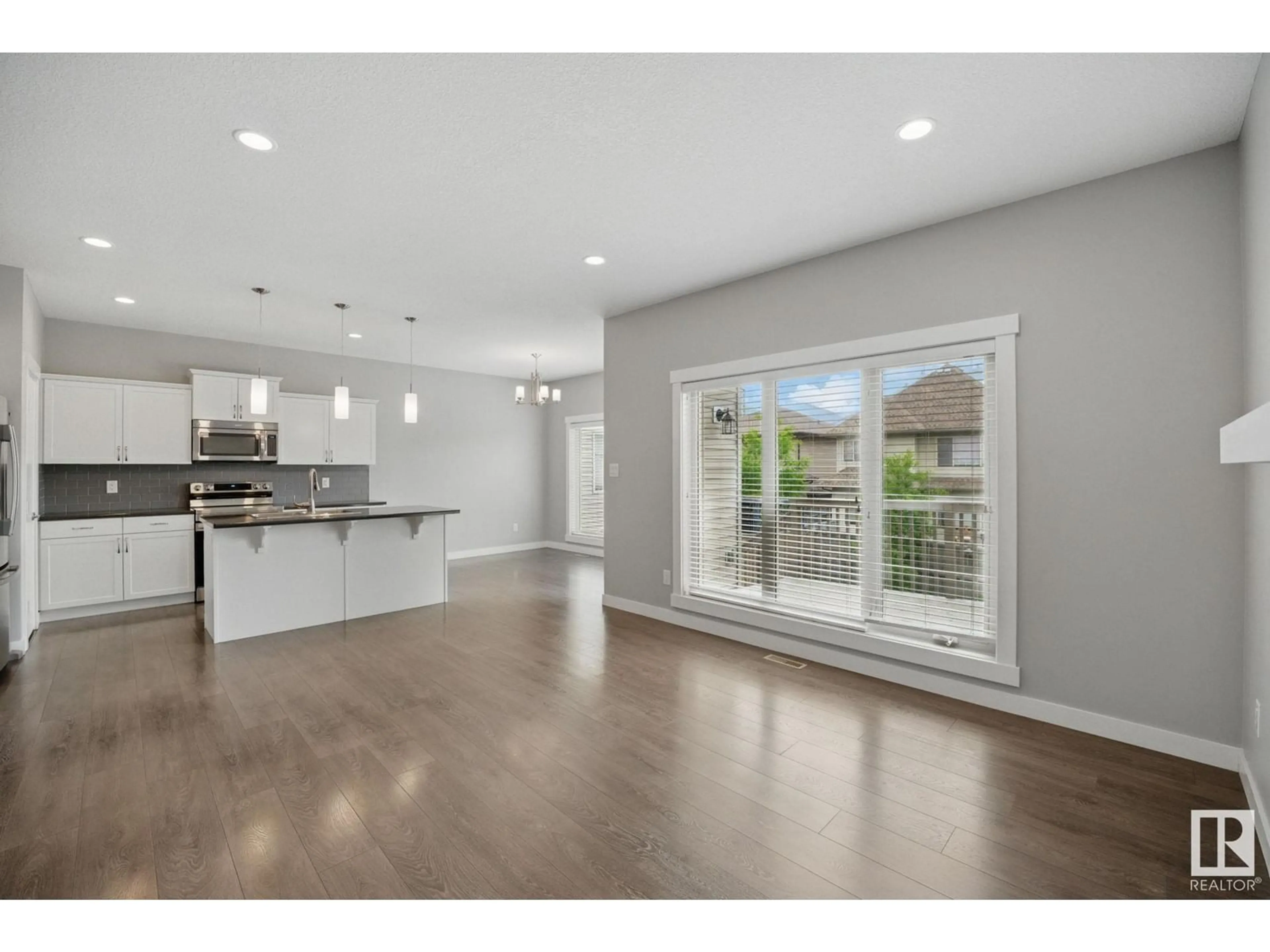 Open concept kitchen, wood/laminate floor for 1342 AINSLIE WD, Edmonton Alberta T6W3G1