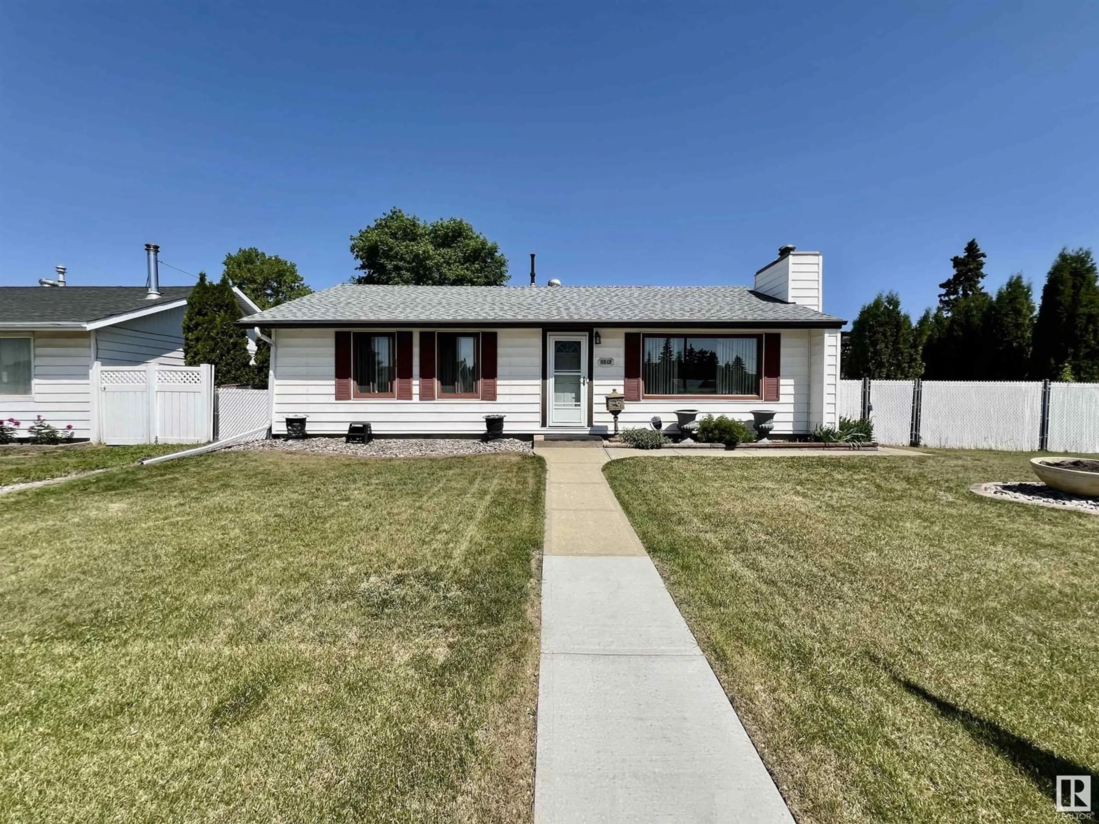 Home with vinyl exterior material, street for 8812 130 AV, Edmonton Alberta T5E0R9