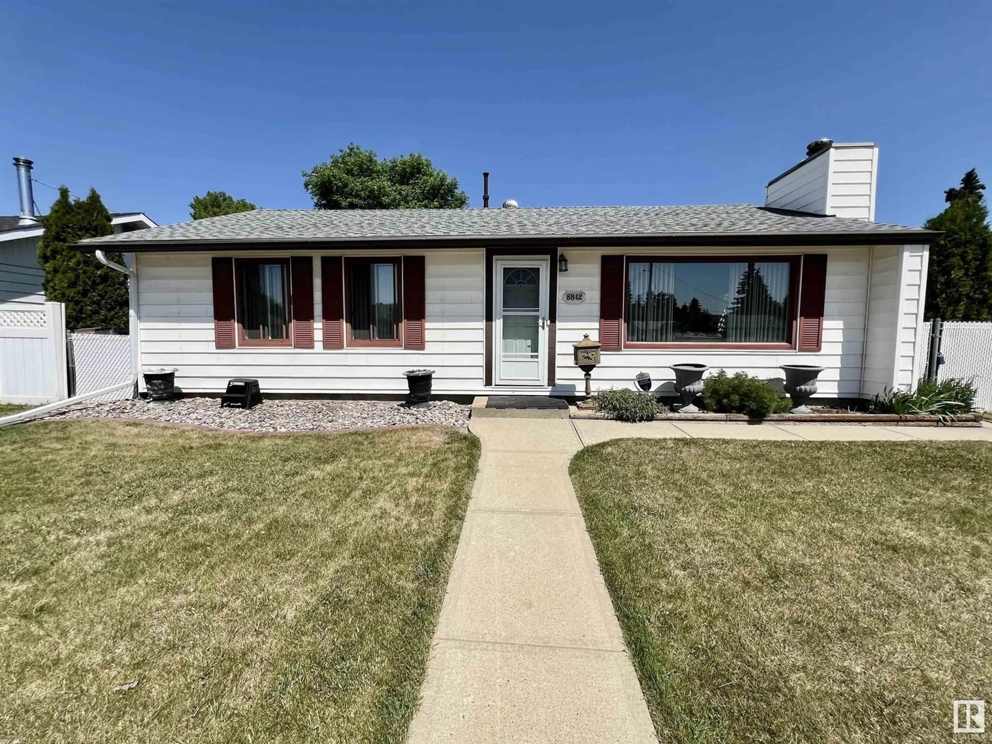 Home with vinyl exterior material, street for 8812 130 AV, Edmonton Alberta T5E0R9