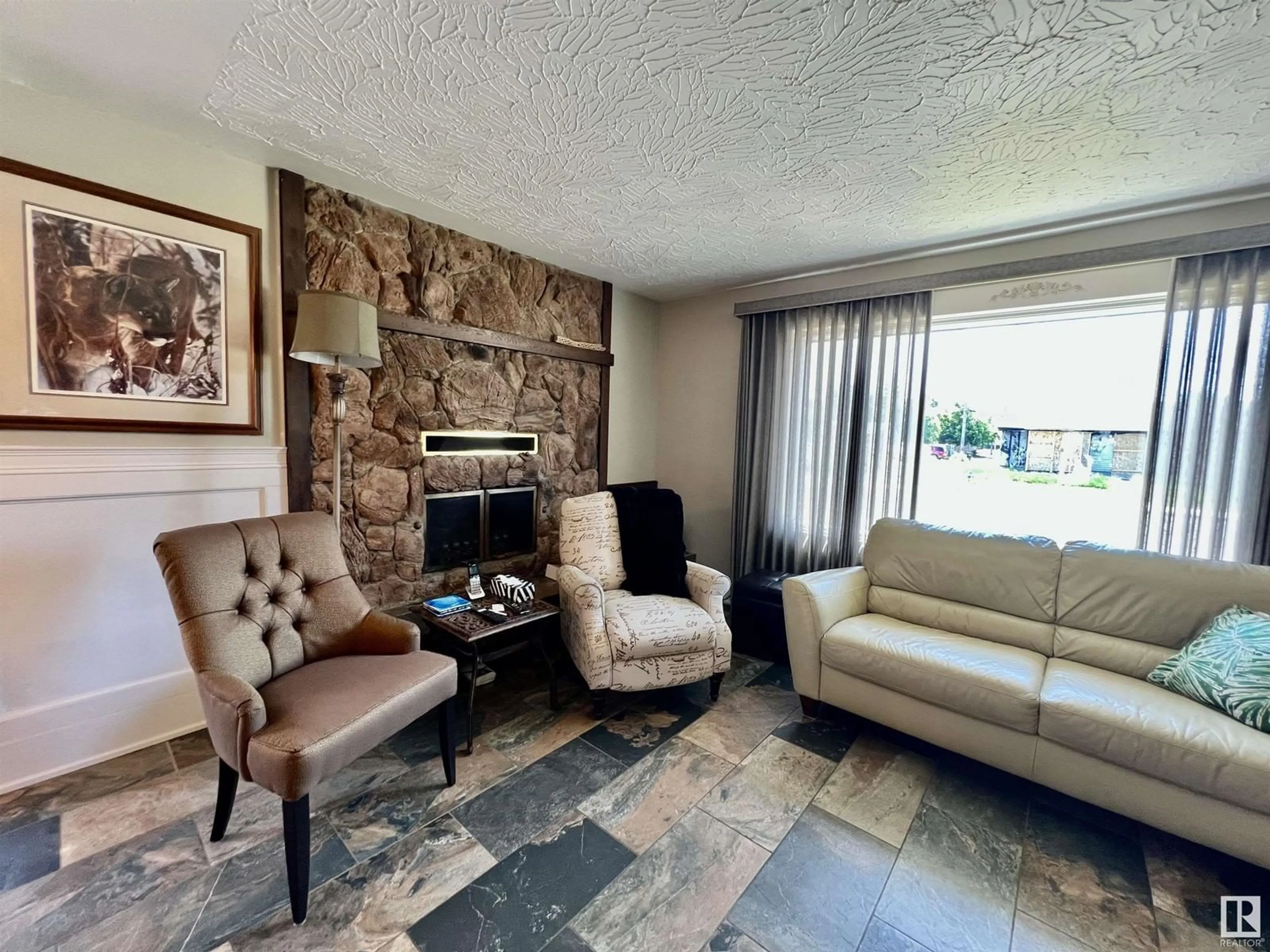 Living room with furniture, ceramic/tile floor for 8812 130 AV, Edmonton Alberta T5E0R9