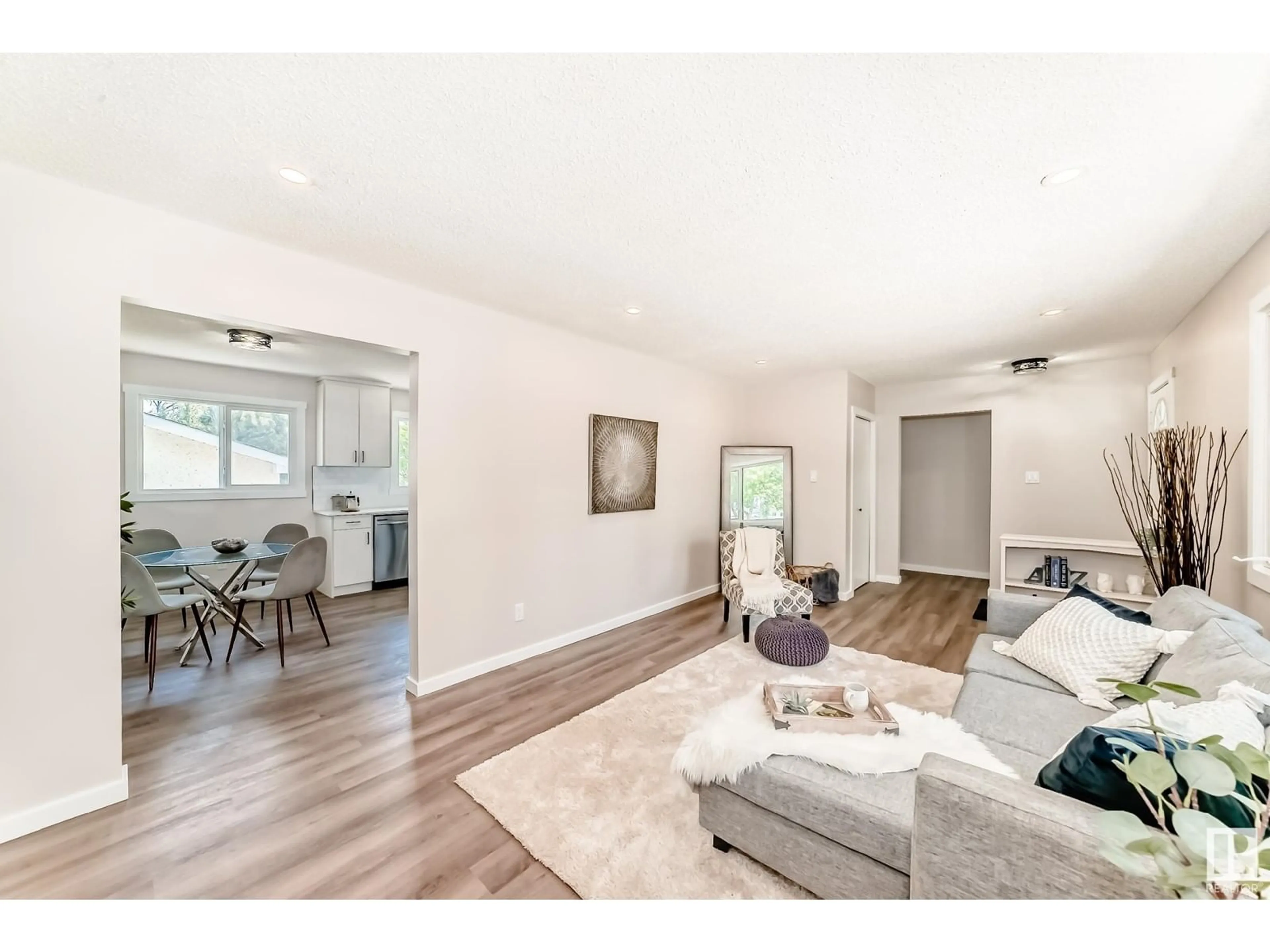 Living room with furniture, wood/laminate floor for 6011 146 AV, Edmonton Alberta T5A1S9