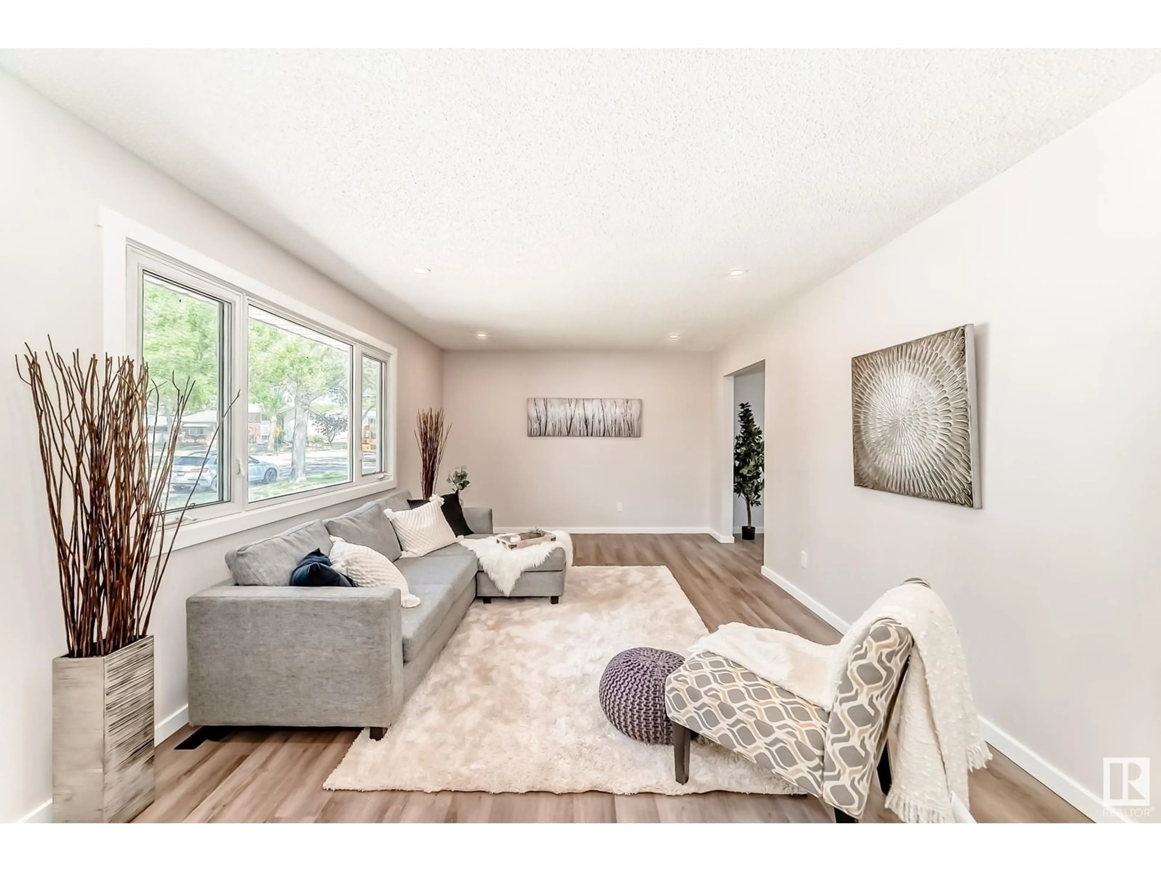 Living room with furniture, wood/laminate floor for 6011 146 AV, Edmonton Alberta T5A1S9