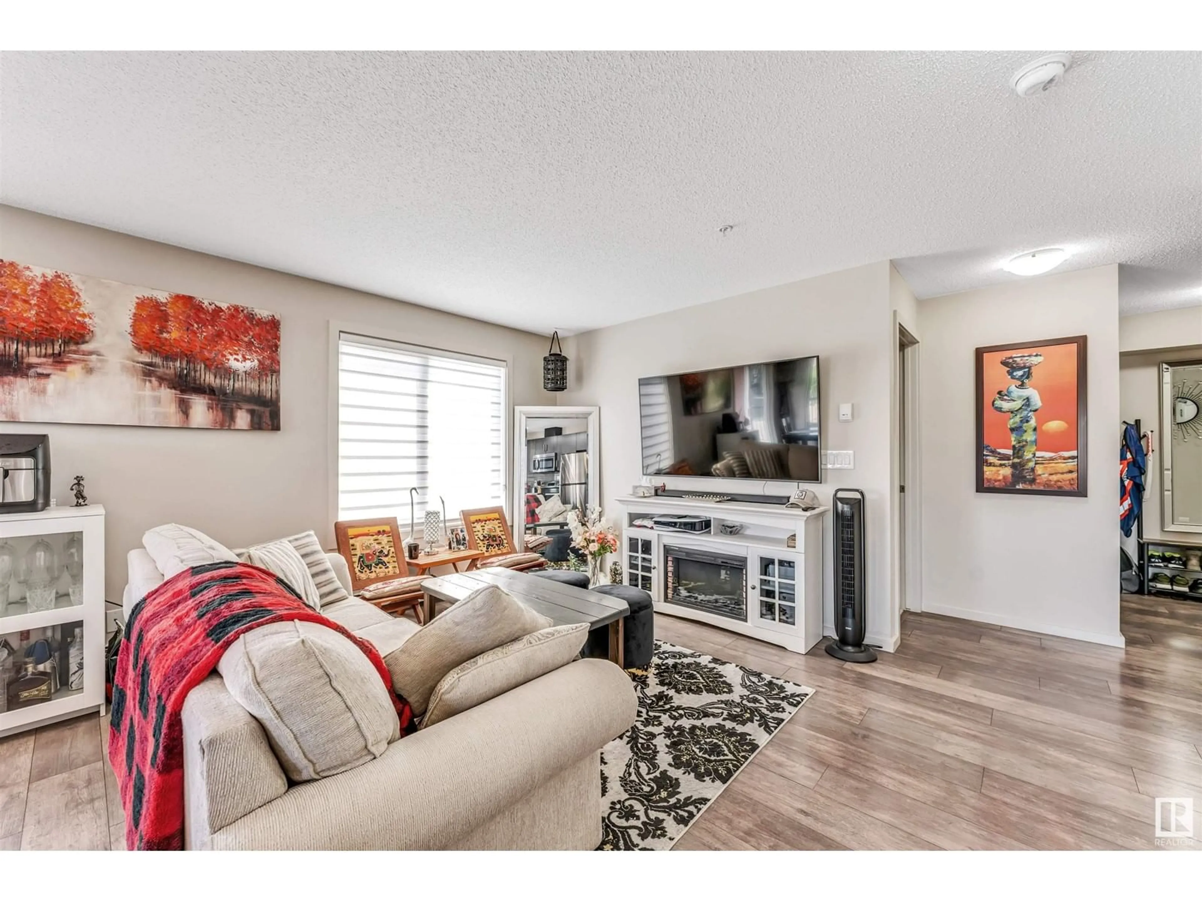 Living room with furniture, wood/laminate floor for 220 - 220 5515 7 AVENUE AVENUE, Edmonton Alberta T6X2A8