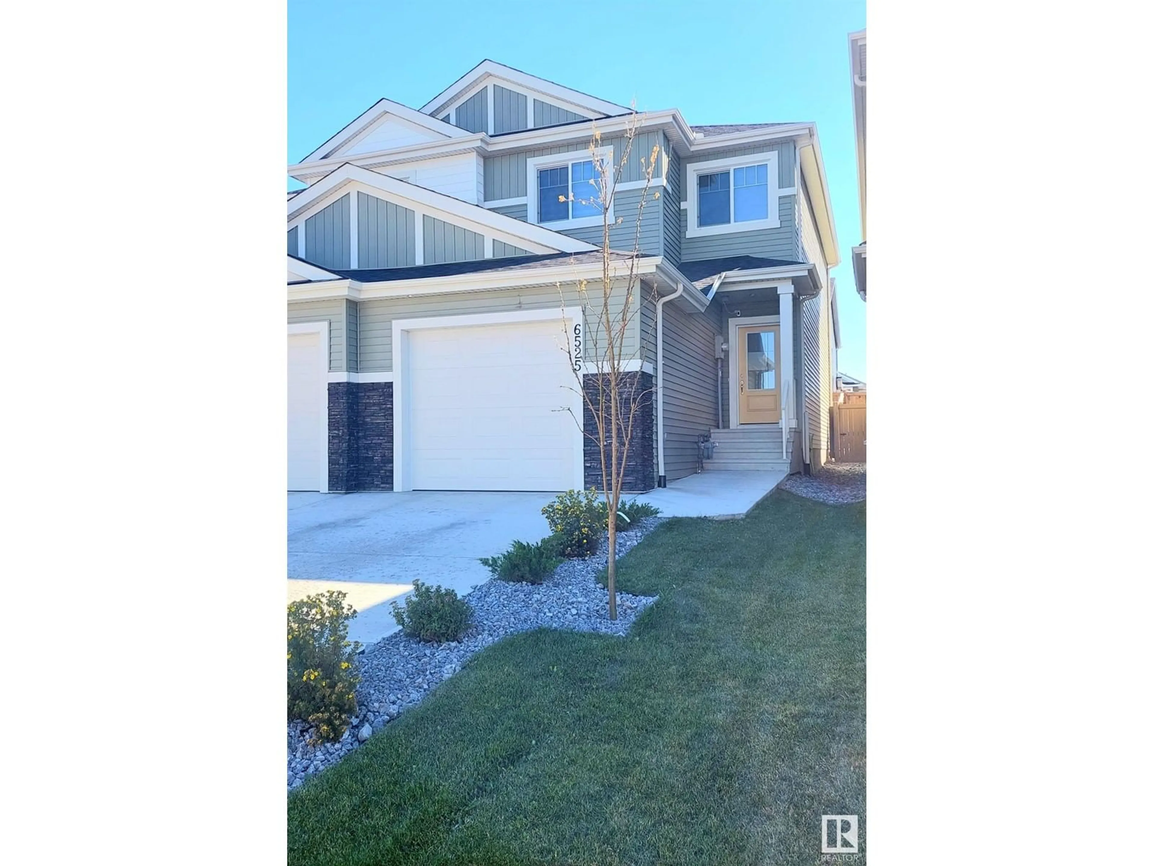 Home with vinyl exterior material, street for NW - 6525 167B AV, Edmonton Alberta T5Y3X8