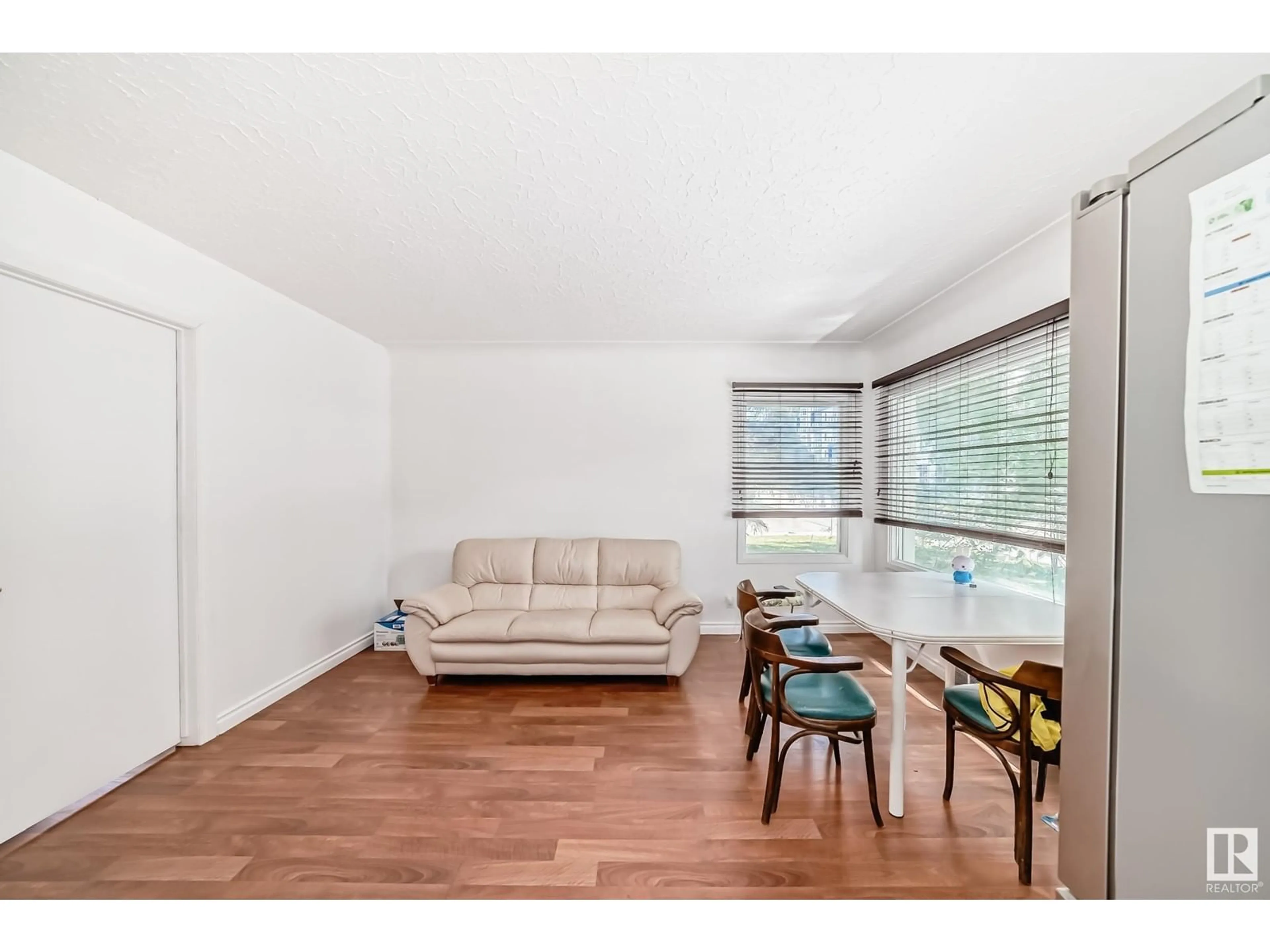 Living room with furniture, wood/laminate floor for 7910 115 ST, Edmonton Alberta T6G1N8