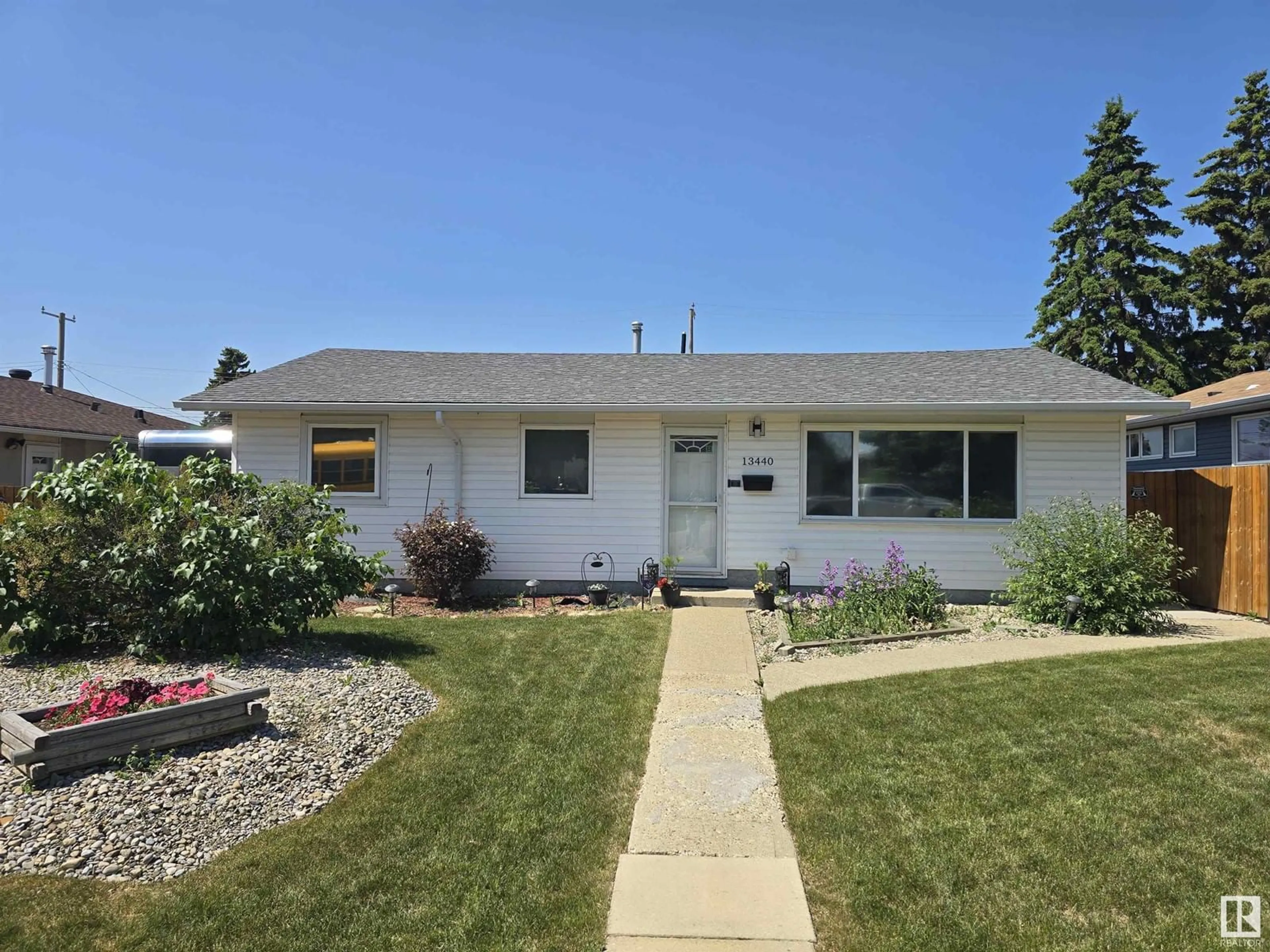 Home with vinyl exterior material, street for 13440 113 ST, Edmonton Alberta T5E5B1