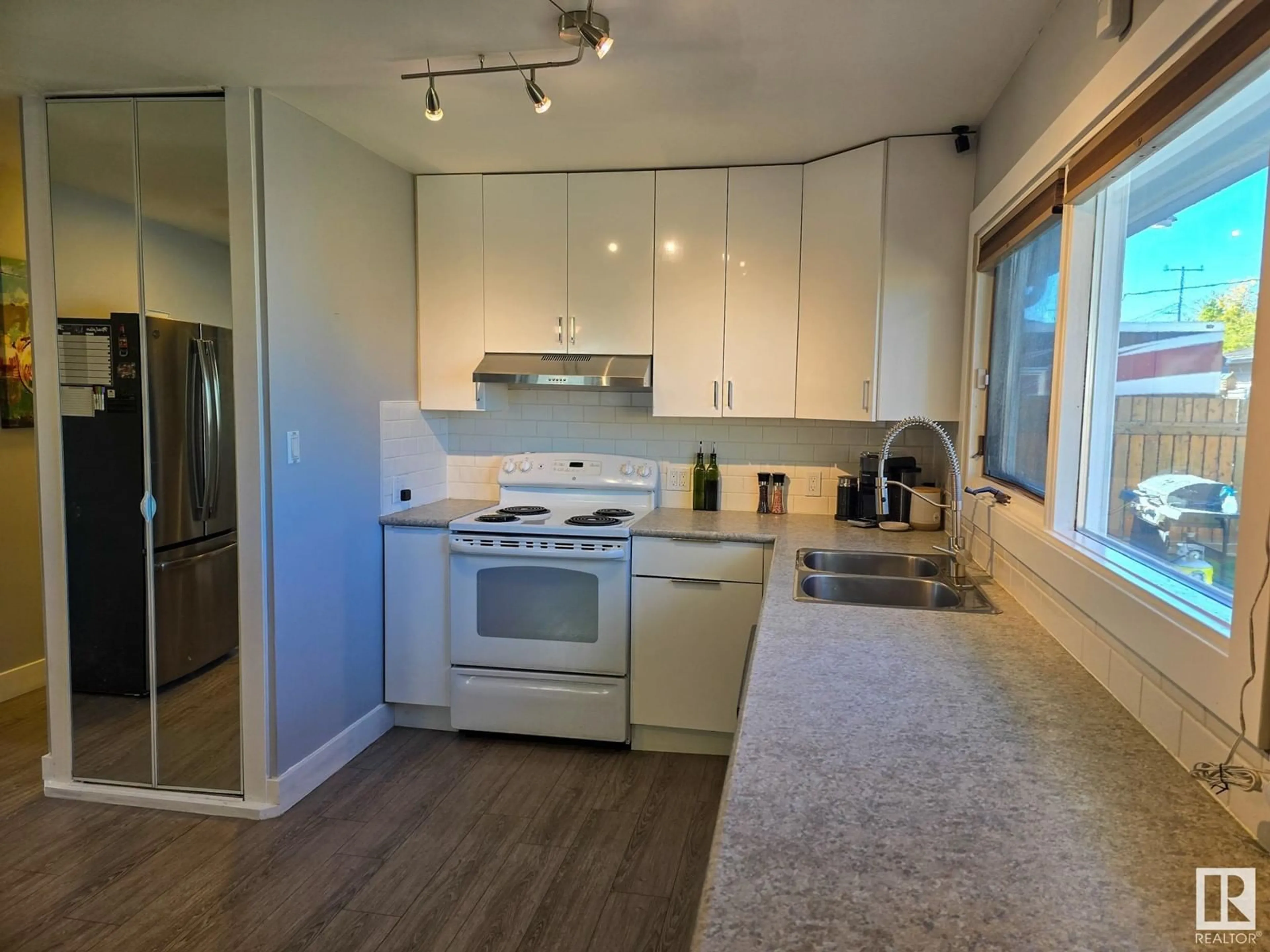 Open concept kitchen, wood/laminate floor for 13440 113 ST, Edmonton Alberta T5E5B1