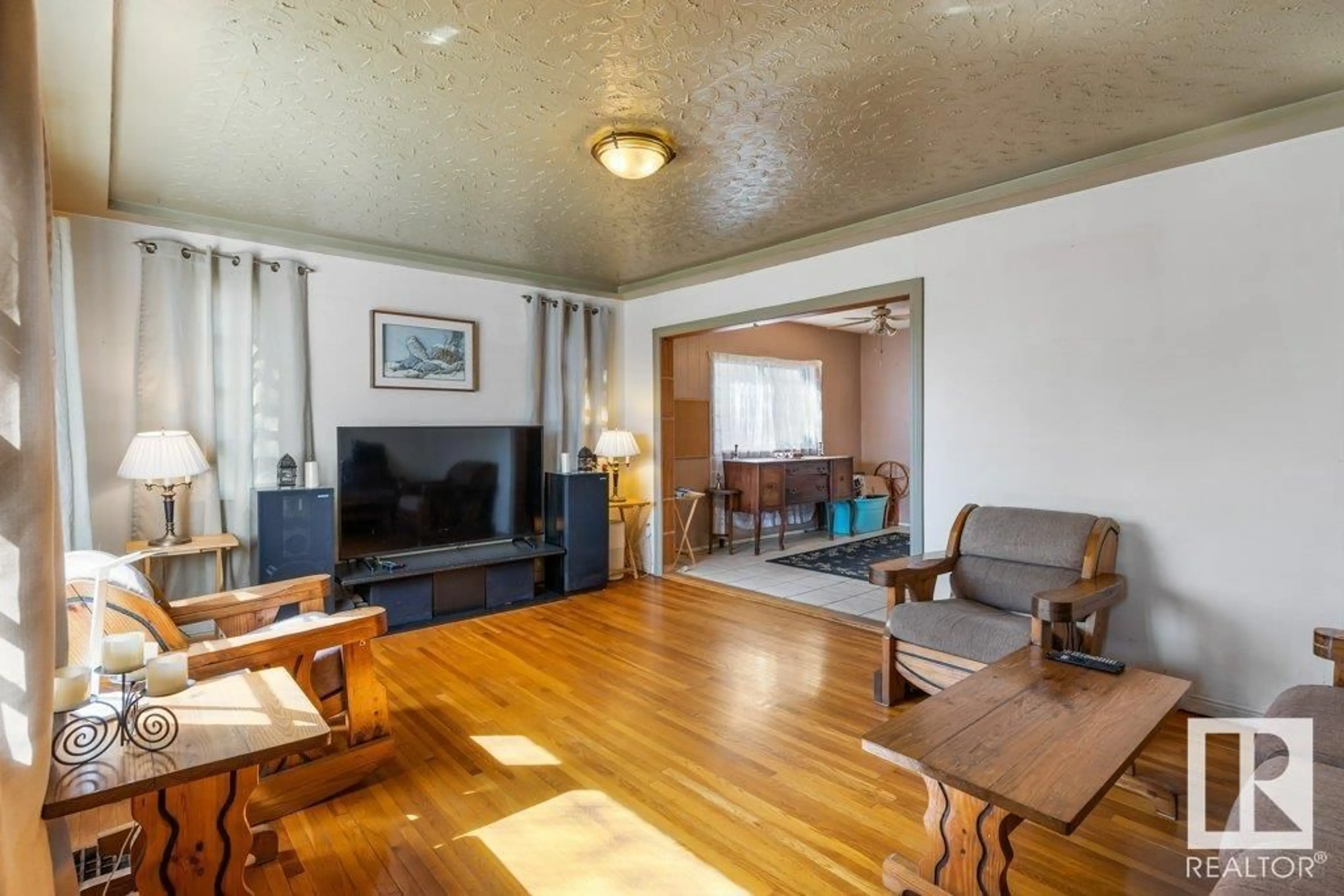 Living room with furniture, wood/laminate floor for NW - 12610 69 ST, Edmonton Alberta T5C0G8