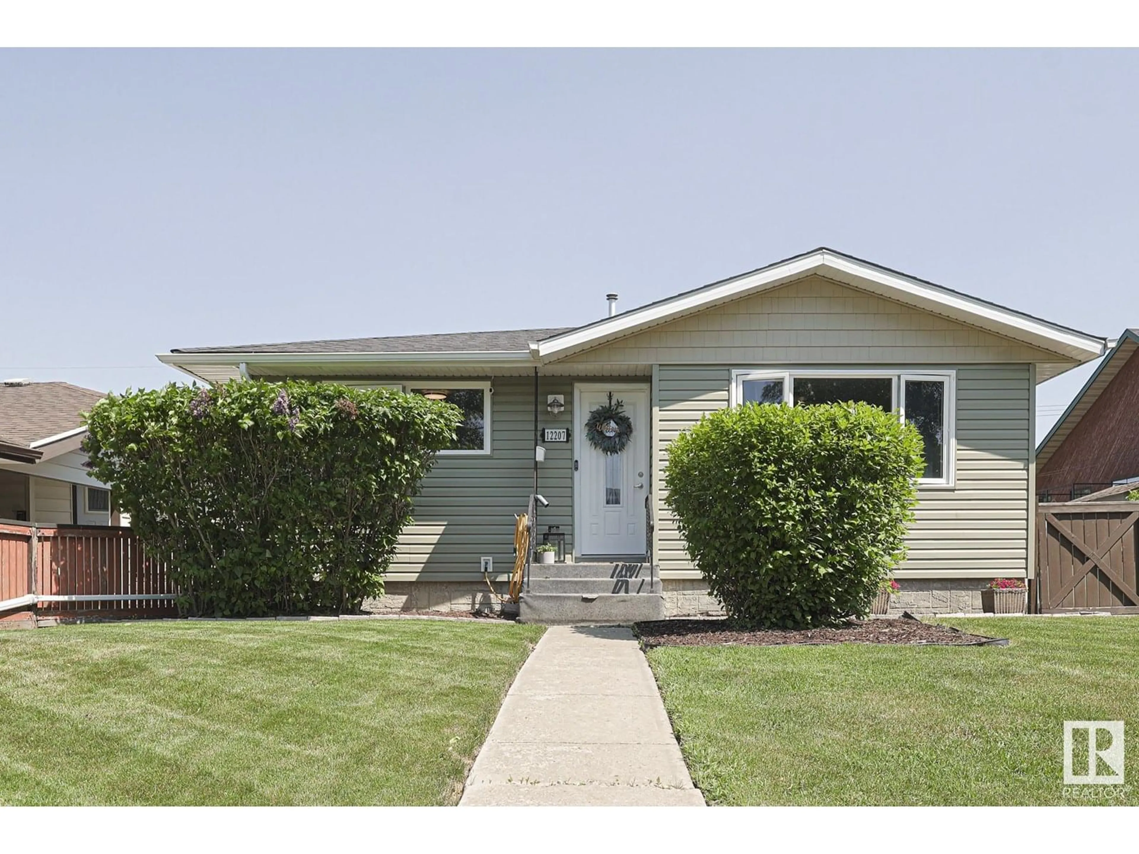 Home with vinyl exterior material, street for NW - 12207 42 ST, Edmonton Alberta T5W2P2